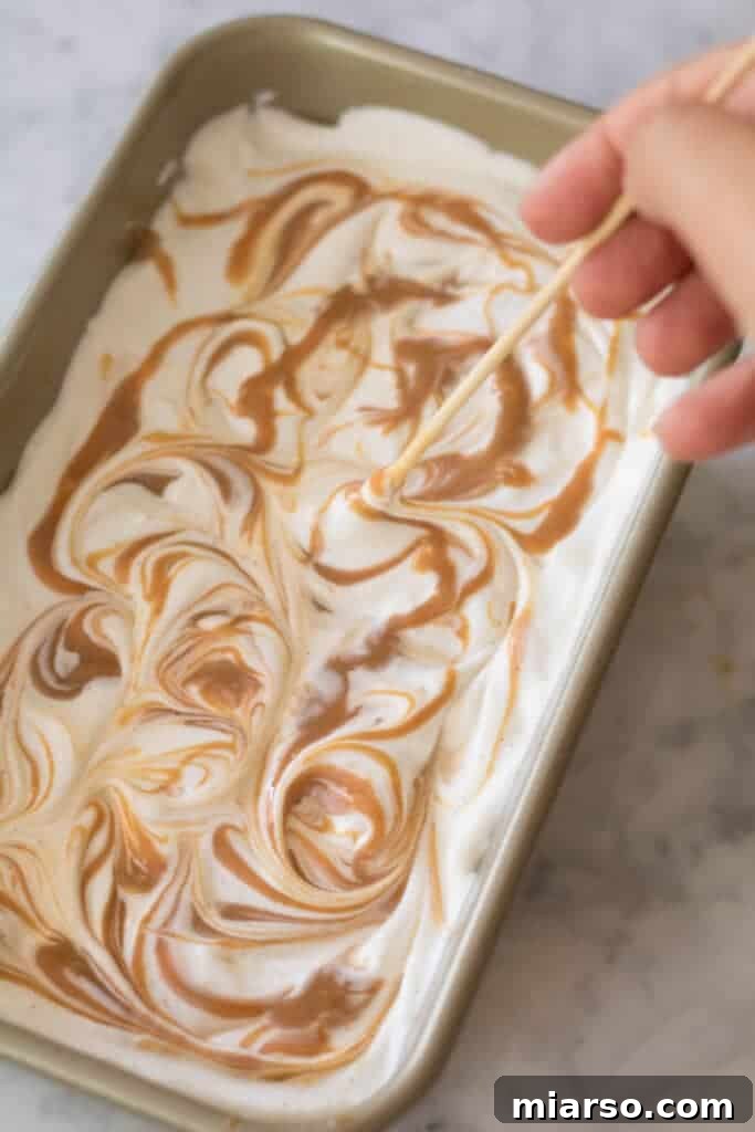 Layering the ice cream mixture and dulce de leche in a chilled loaf pan