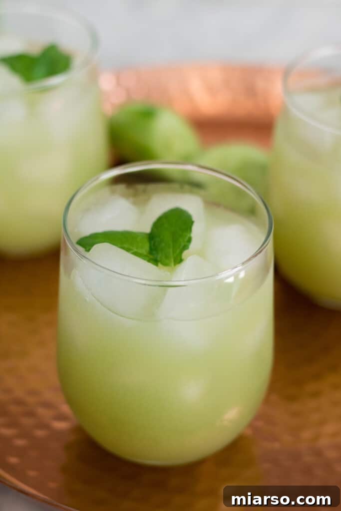 Vibrant green cucumber grape lemon cooler in a glass, perfect for summer refreshment.