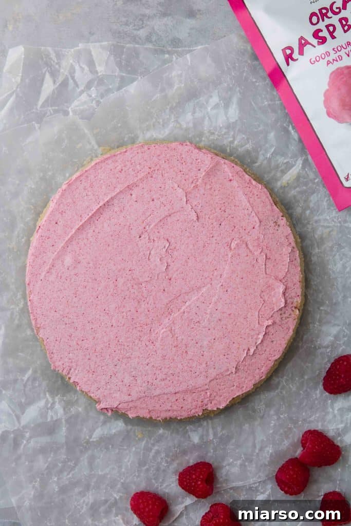 Raspberry Bliss Cake with Silky Buttercream 6 Starting a buttercream rosette on a cake