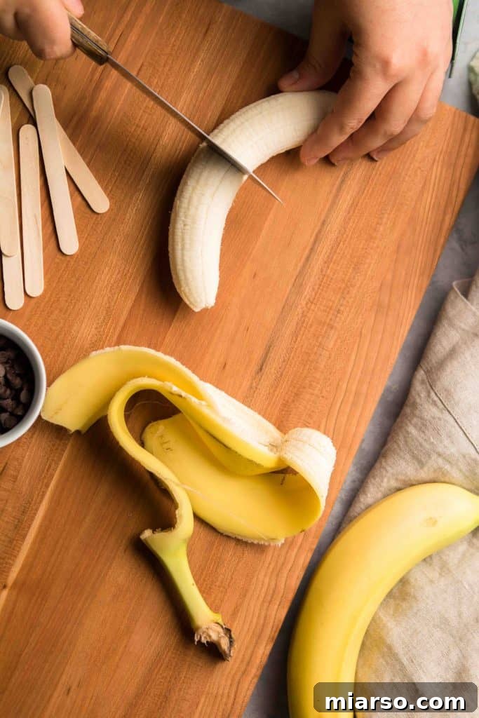Step-by-step: Inserting popsicle sticks into bananas for Boonanas
