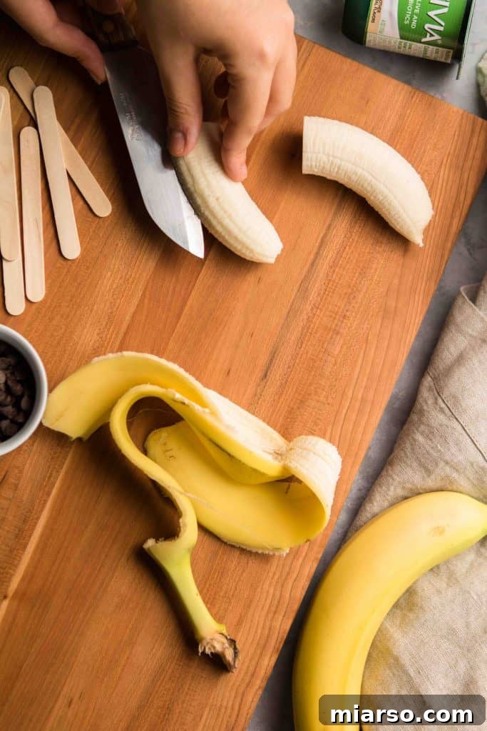 Step-by-step: Dipping frozen bananas into vanilla yogurt