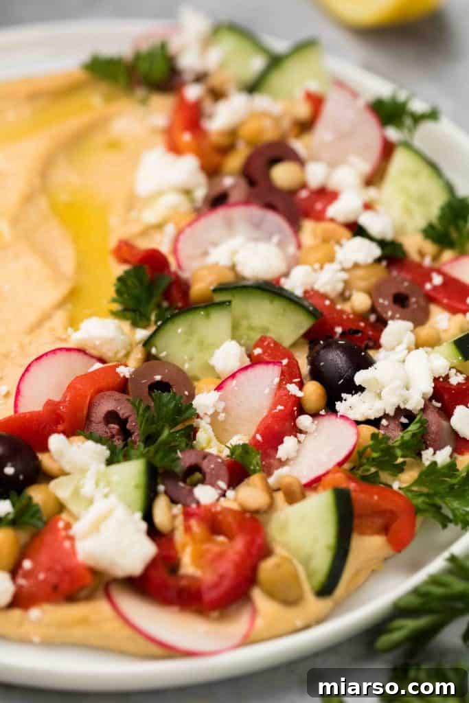 Effortless Mediterranean Hummus Platter 2 Easy Mediterranean loaded hummus appetizer with fresh vegetables and pita chips