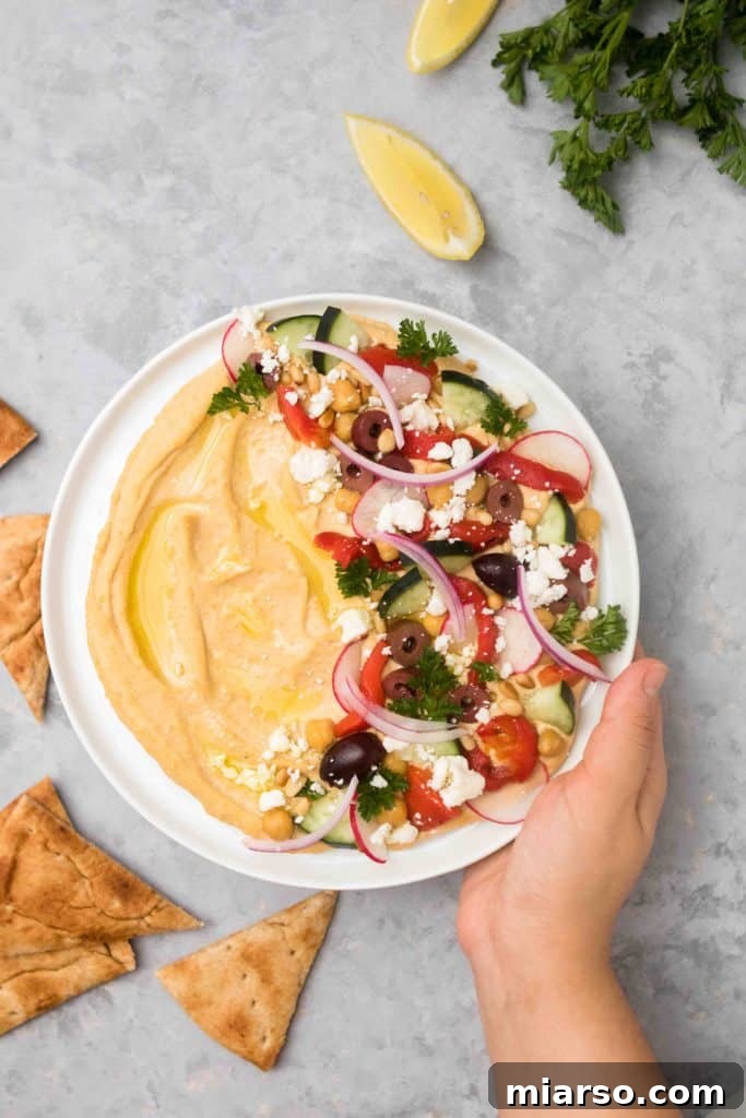 Effortless Mediterranean Hummus Platter 8 Easy loaded hummus appetizer served with flatbread and fresh vegetables