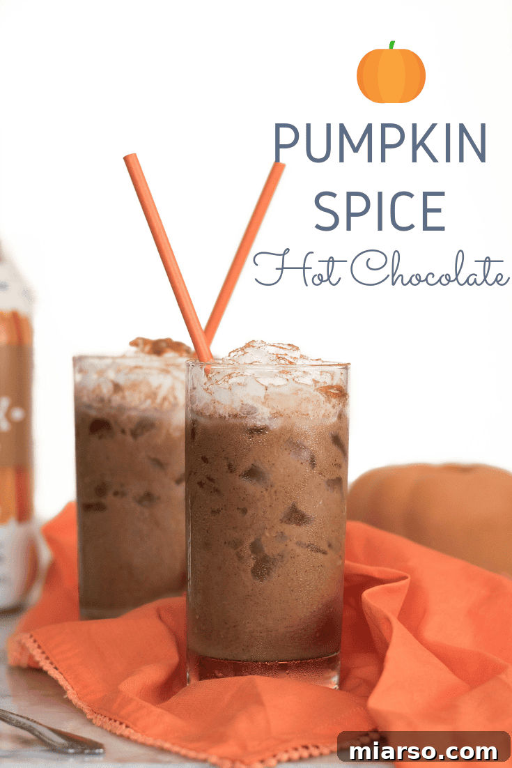 The Ultimate Vegan Iced Pumpkin Spice Hot Chocolate 11 Vertical shot of Iced Vegan Pumpkin Spice Hot Chocolate in a tall glass