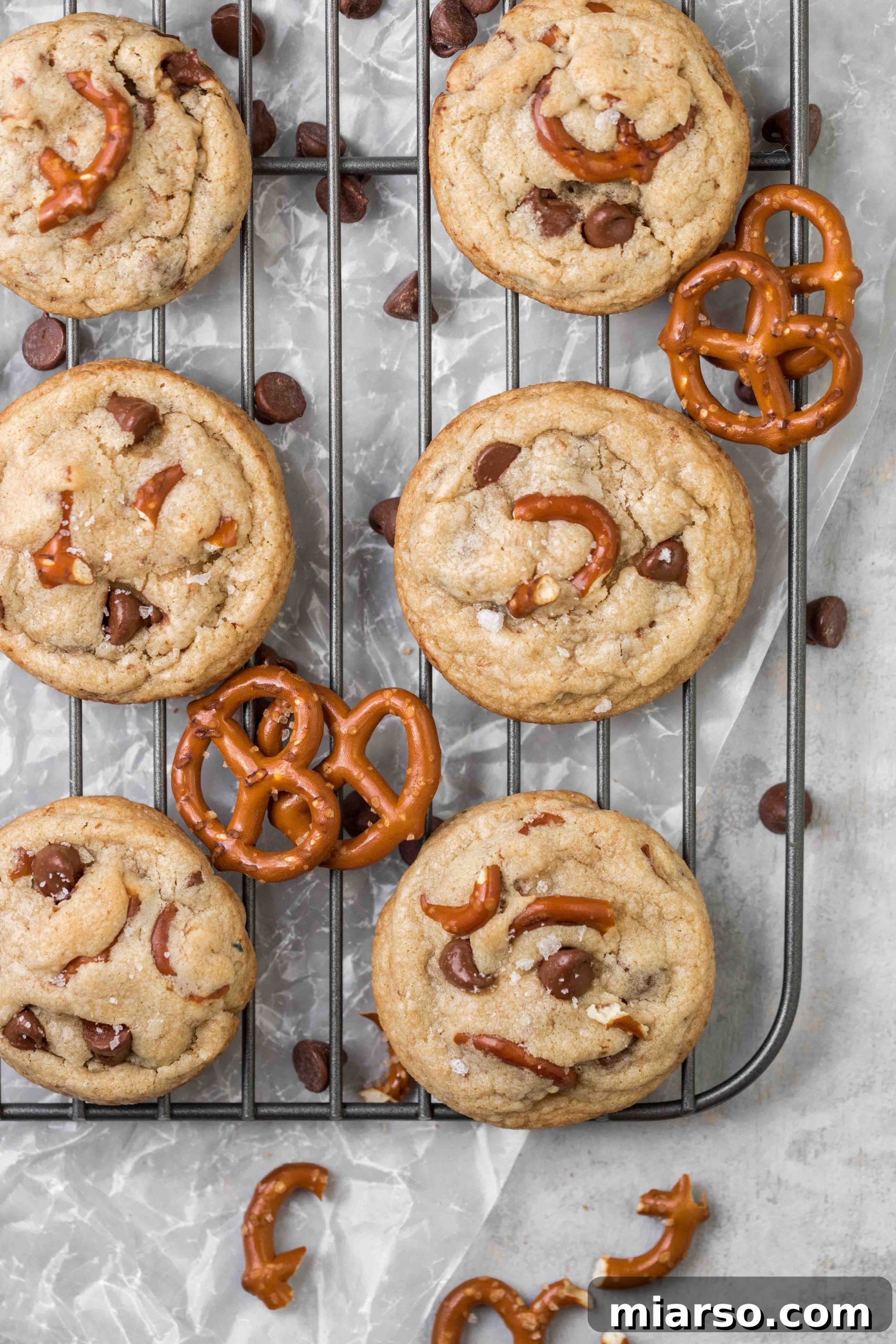 Bowl of cookie dough with chocolate chips and crushed pretzels, ready to be scooped.