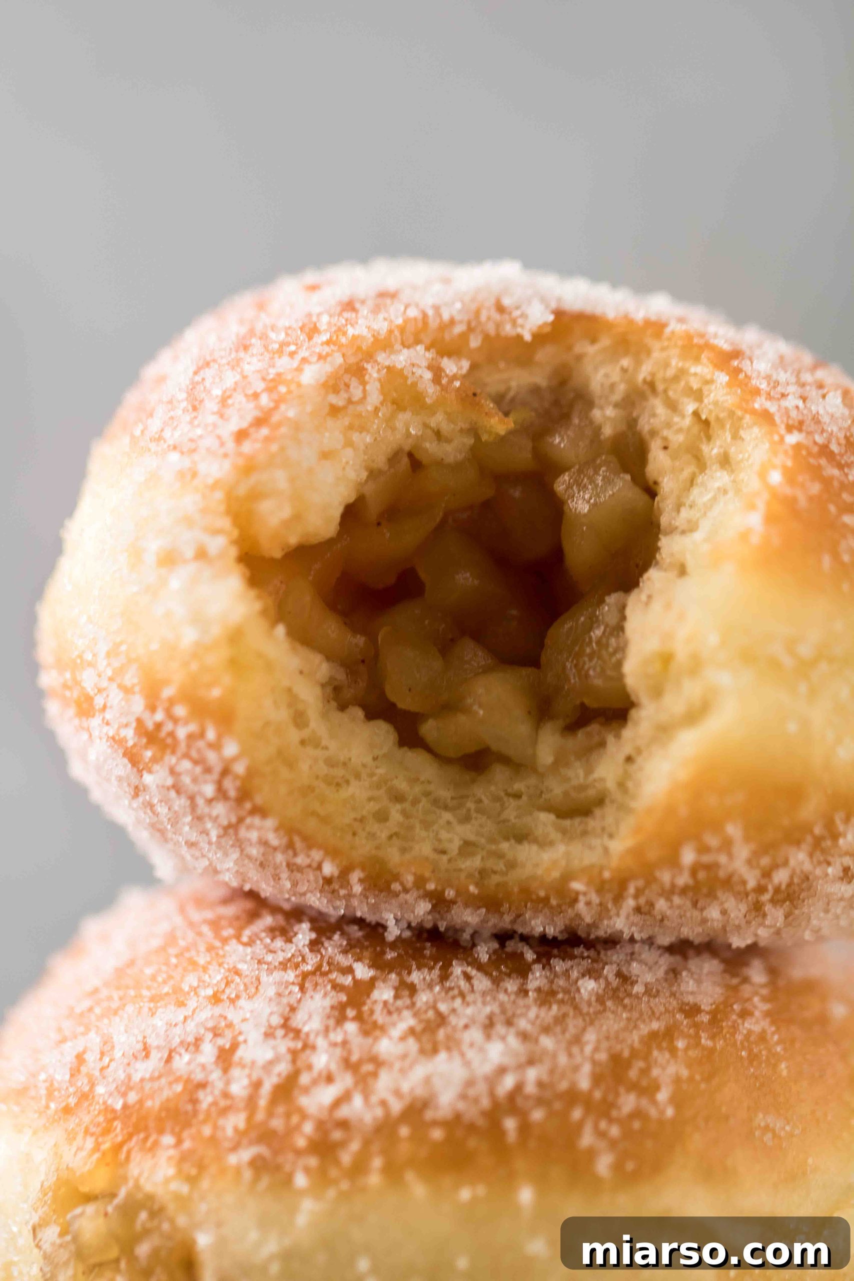 Delightful homemade apple stuffed donuts, golden brown and perfectly prepared