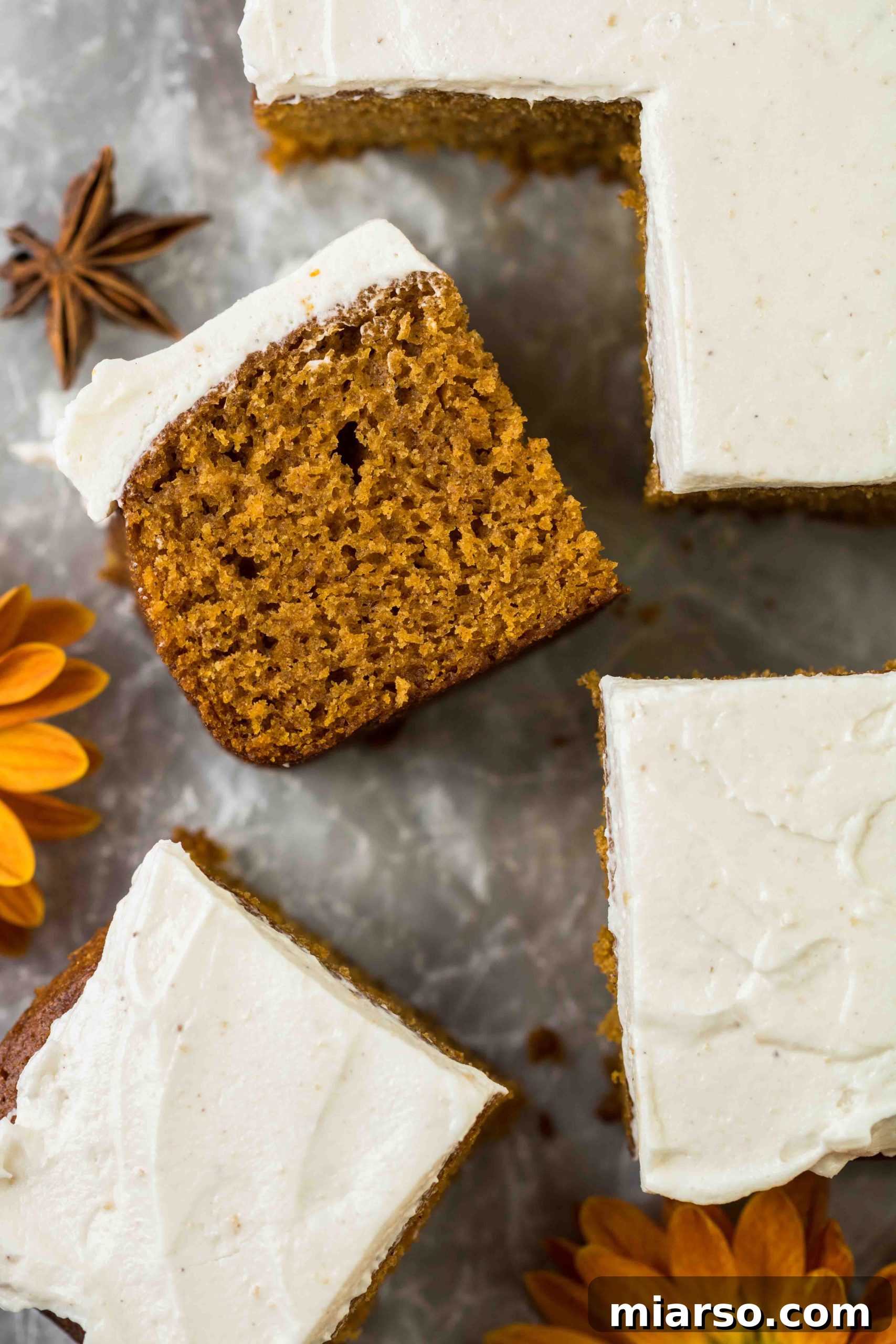 Unbelievably Easy & Moist Pumpkin Sheet Cake 4 Close up of a moist pumpkin sheet cake with frosting