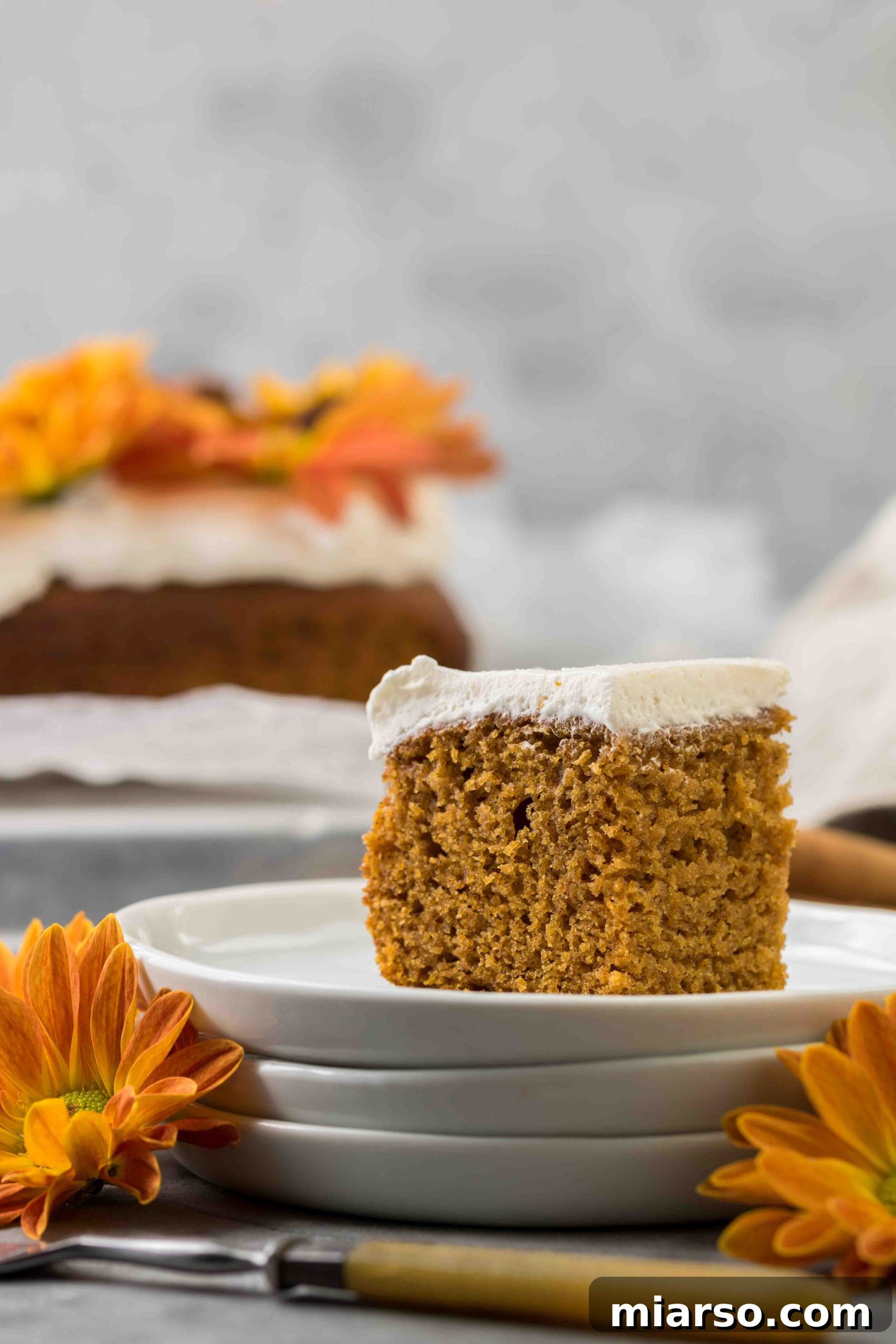 Unbelievably Easy & Moist Pumpkin Sheet Cake 7 Decorated pumpkin sheet cake with fall flowers and star anise