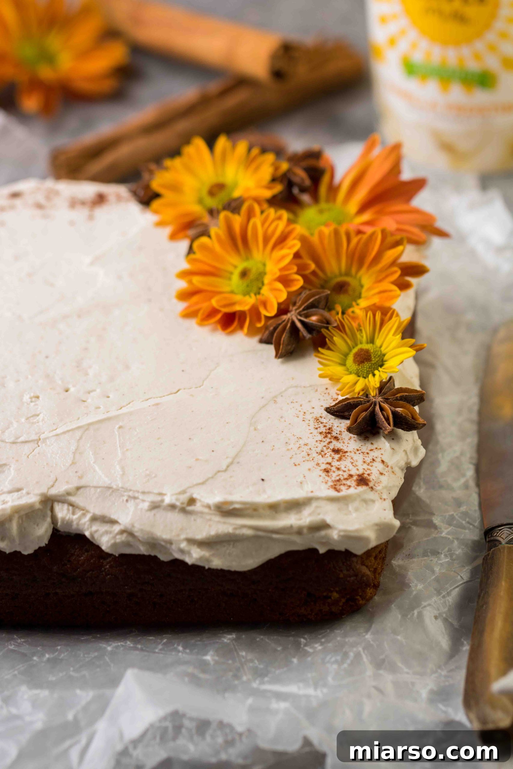 Unbelievably Easy & Moist Pumpkin Sheet Cake 8 Close up of pumpkin sheet cake with vanilla frosting and decoration