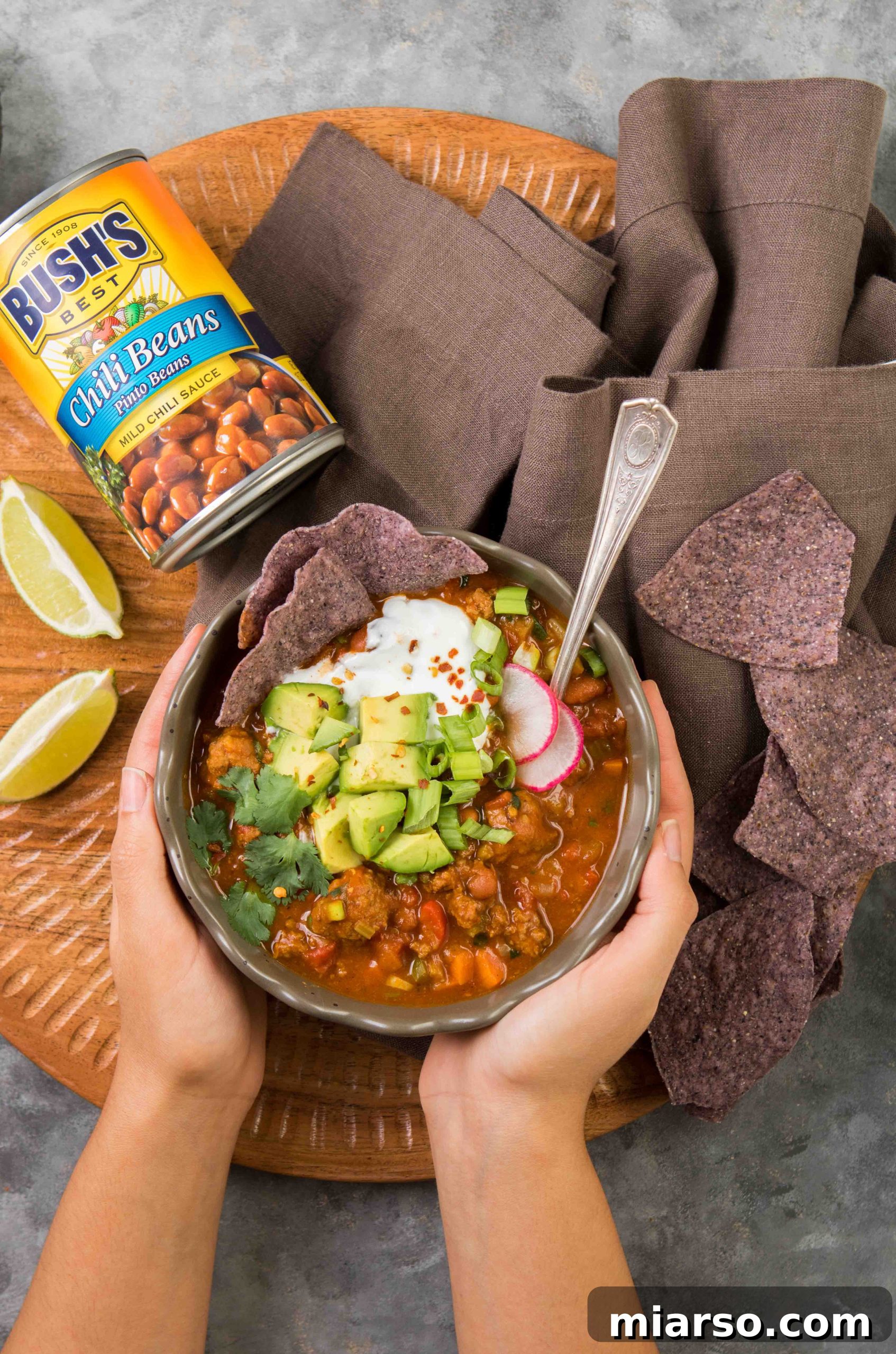 Delicious Mediterranean Chili recipe with a twist, garnished with fresh herbs and sour cream