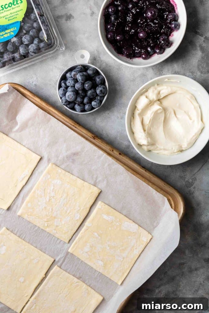 Flaky Blueberry Cheese Danish Made Easy 5 Step-by-step: Rolling out puff pastry for blueberry cheese danish.