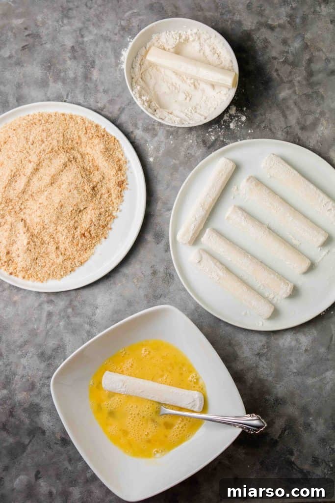 Airfryer'da Kusursuz Mozzarella Çubukları 6 Mozzarella sticks dipped in egg wash