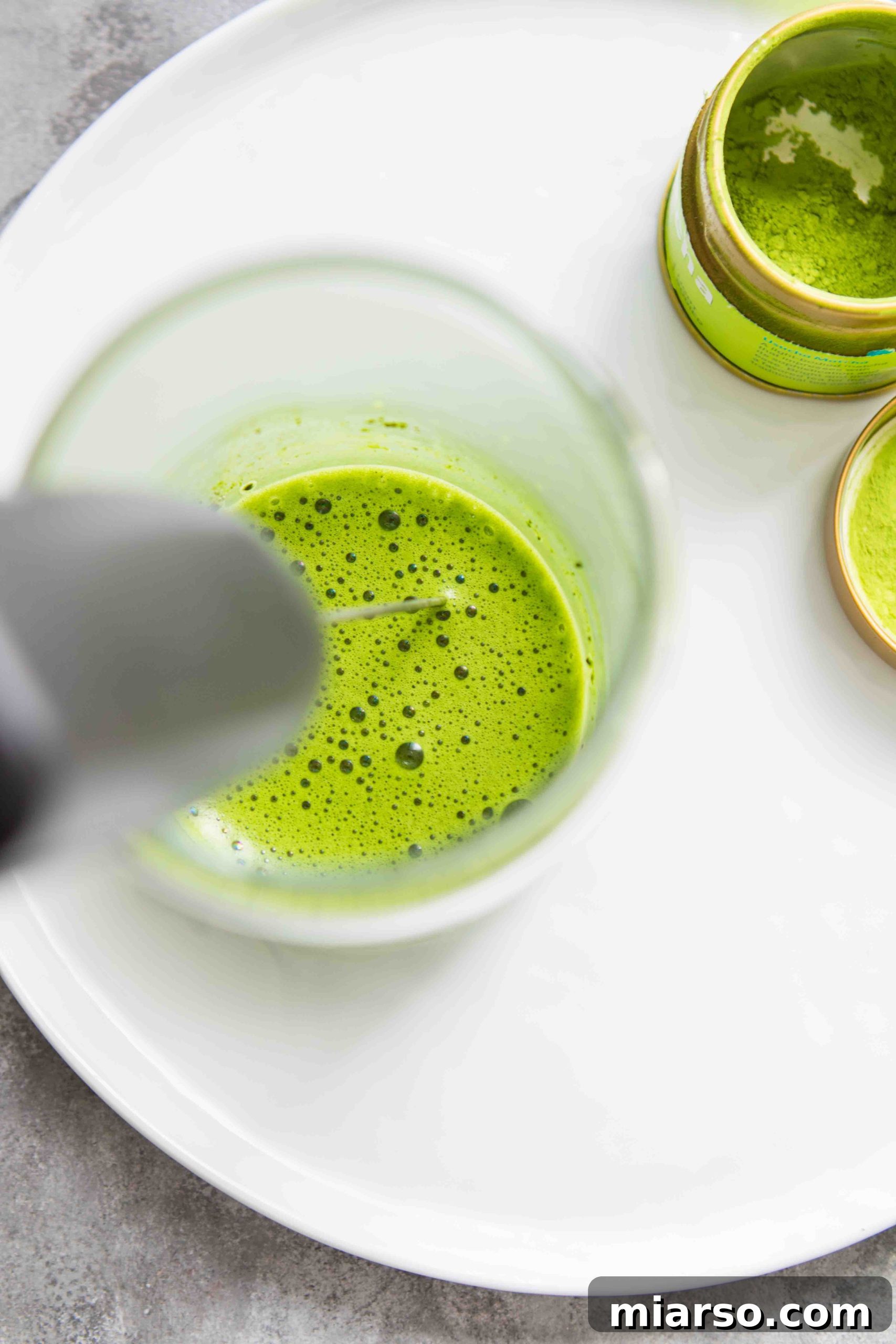 Simple DIY Starbucks Iced Matcha Latte 4 Overhead shot of matcha being mixed for a matcha latte