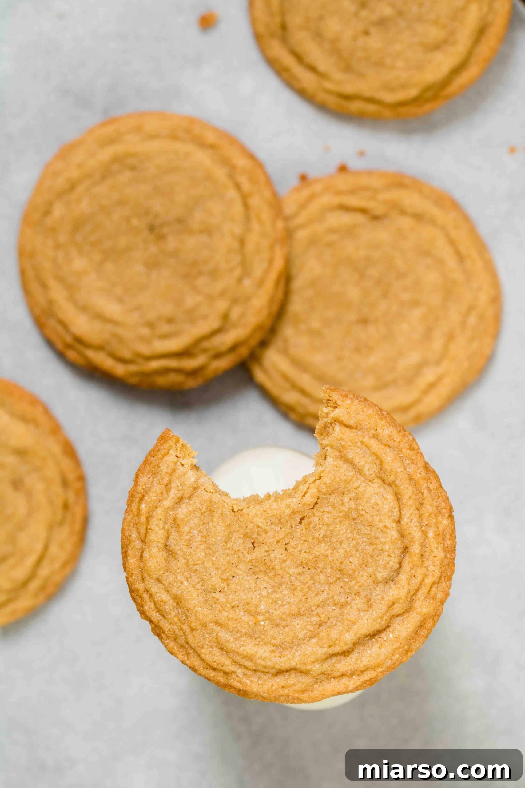 Overhead shot of brown sugar cookies with a bite taken out, showing the soft, chewy interior.