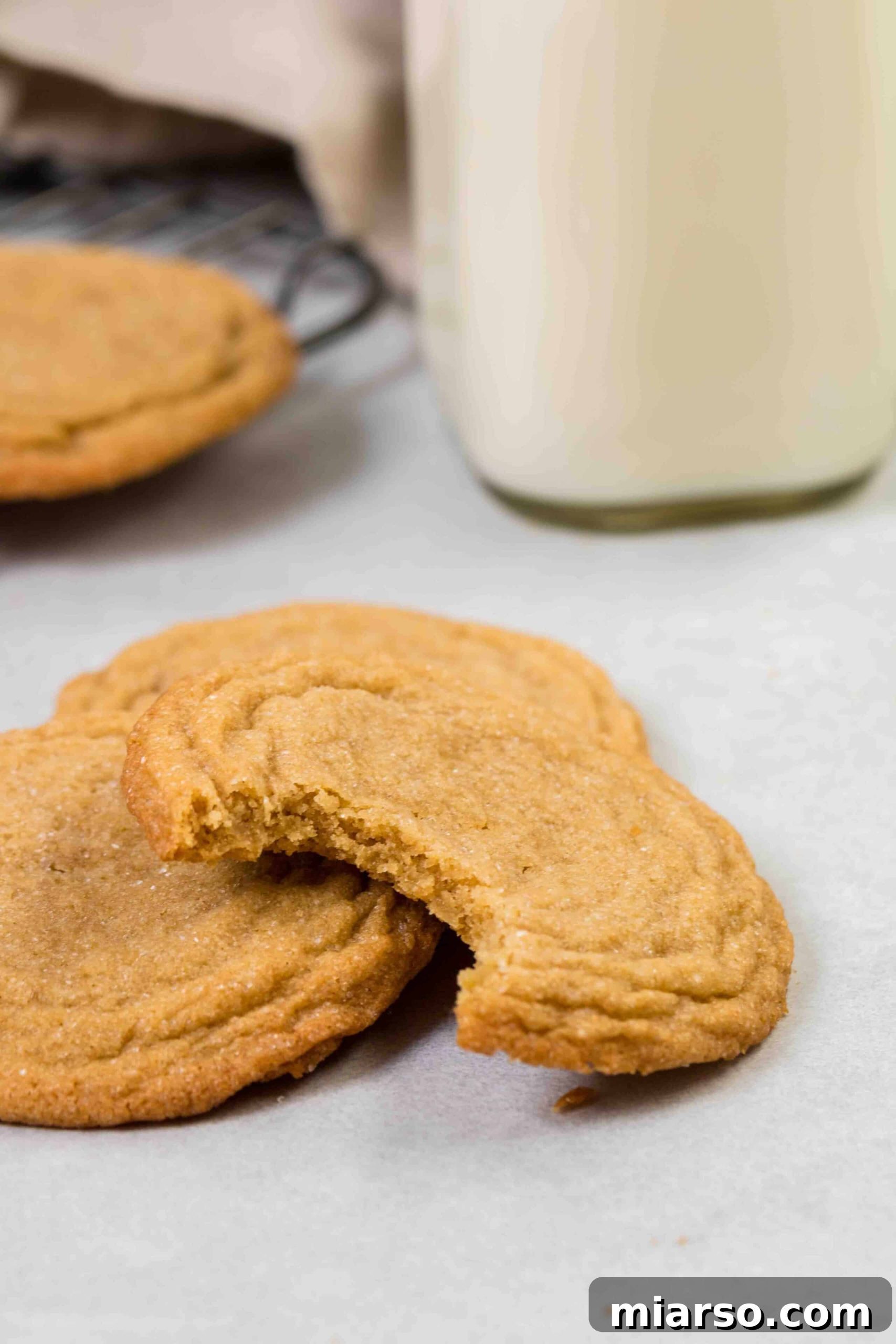 Easy and chewy brown sugar cookies with a bite taken, showcasing the soft interior.