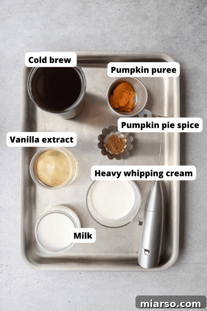 Fall's Ultimate Starbucks Pumpkin Cream Cold Brew 3 A selection of fresh ingredients laid out for making pumpkin cream cold foam, including heavy cream, milk, pumpkin puree, and spices.