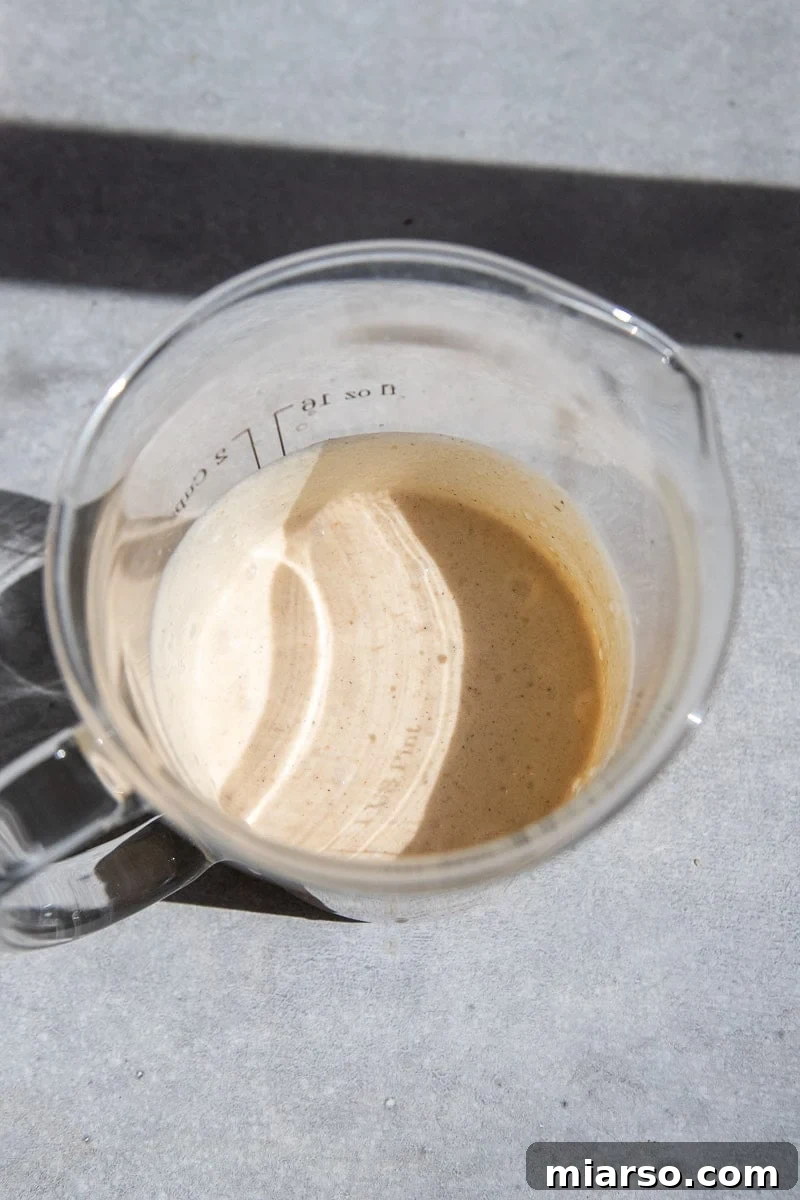 Fall's Ultimate Starbucks Pumpkin Cream Cold Brew 6 A vibrant glass of pumpkin cold foam cold brew, showing the layers of coffee and cream.