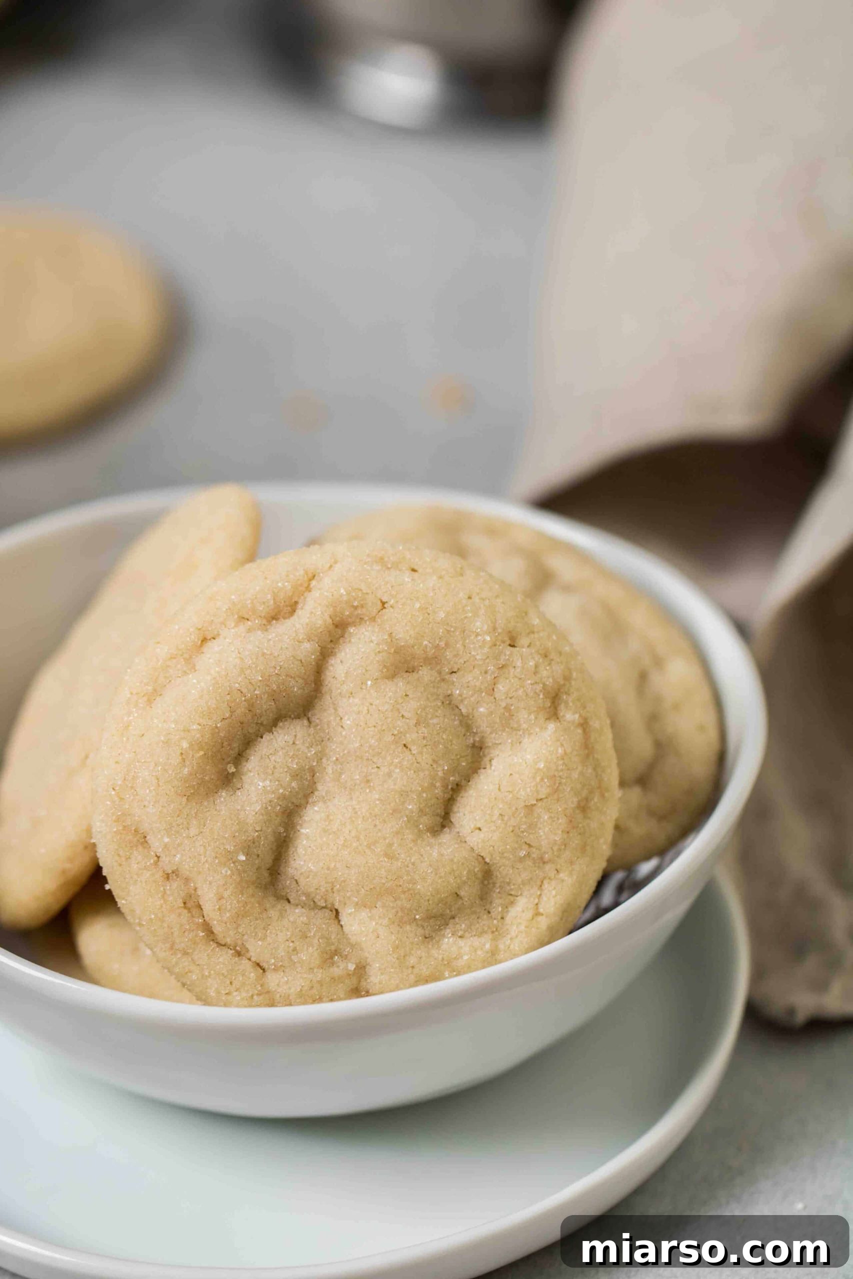 A close-up shot revealing the exquisite, soft texture of vanilla sugar cookies, with tiny cracks on the surface.