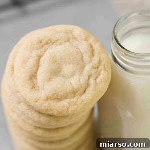 Stack of super soft sugar cookies, invitingly golden and perfectly baked.
