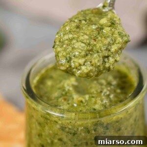 Effortless Homemade Pesto Perfection 10 Close up of homemade pesto in a spoon recipe, ready to be enjoyed.