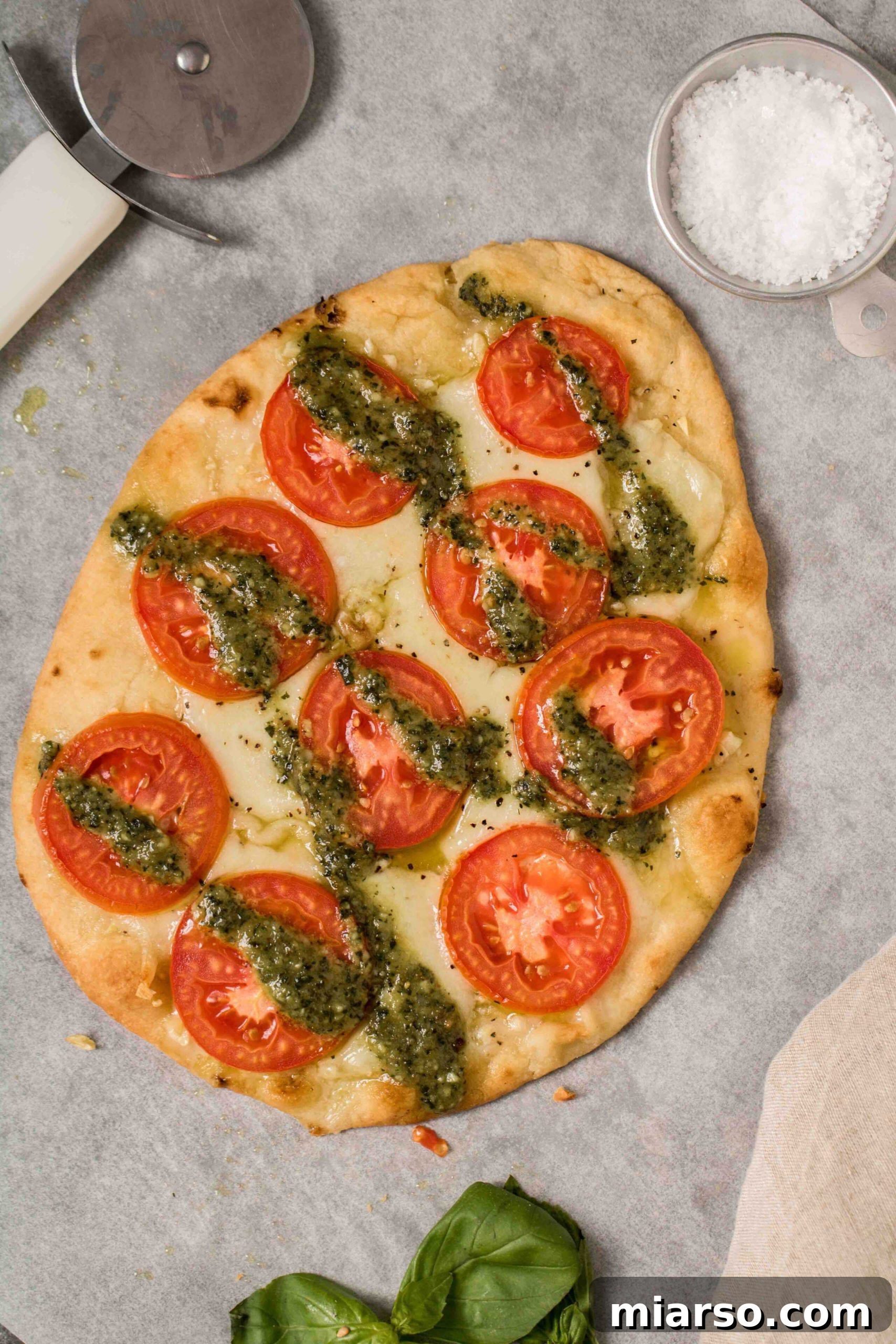 Easy flatbread Margherita pizza with vibrant pesto and fresh basil garnish