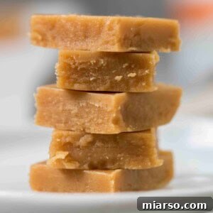 Stack of keto peanut butter fudge squares, creamy and inviting.