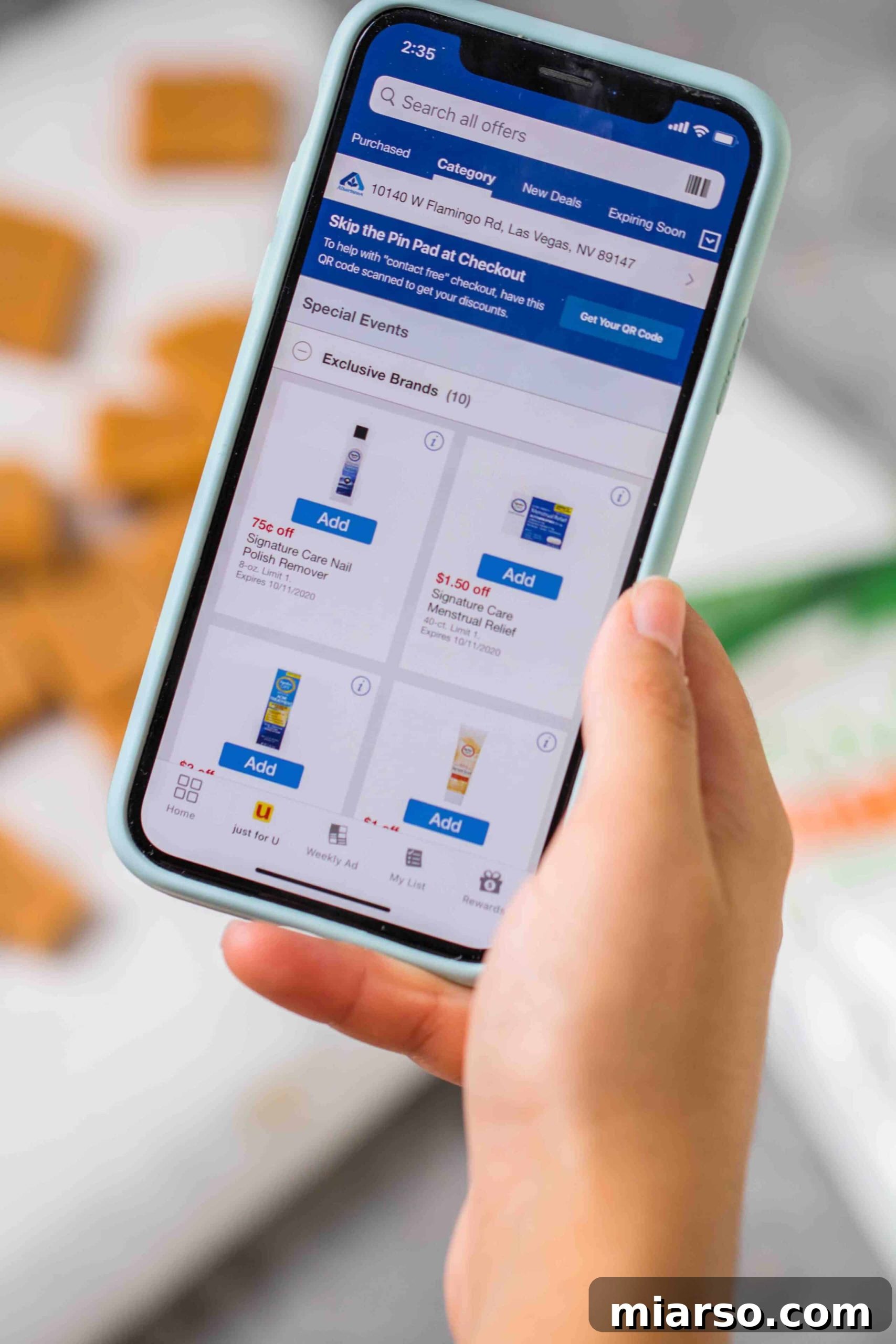 Close up of a phone displaying the Albertsons mobile app, illustrating convenient grocery shopping for keto ingredients.
