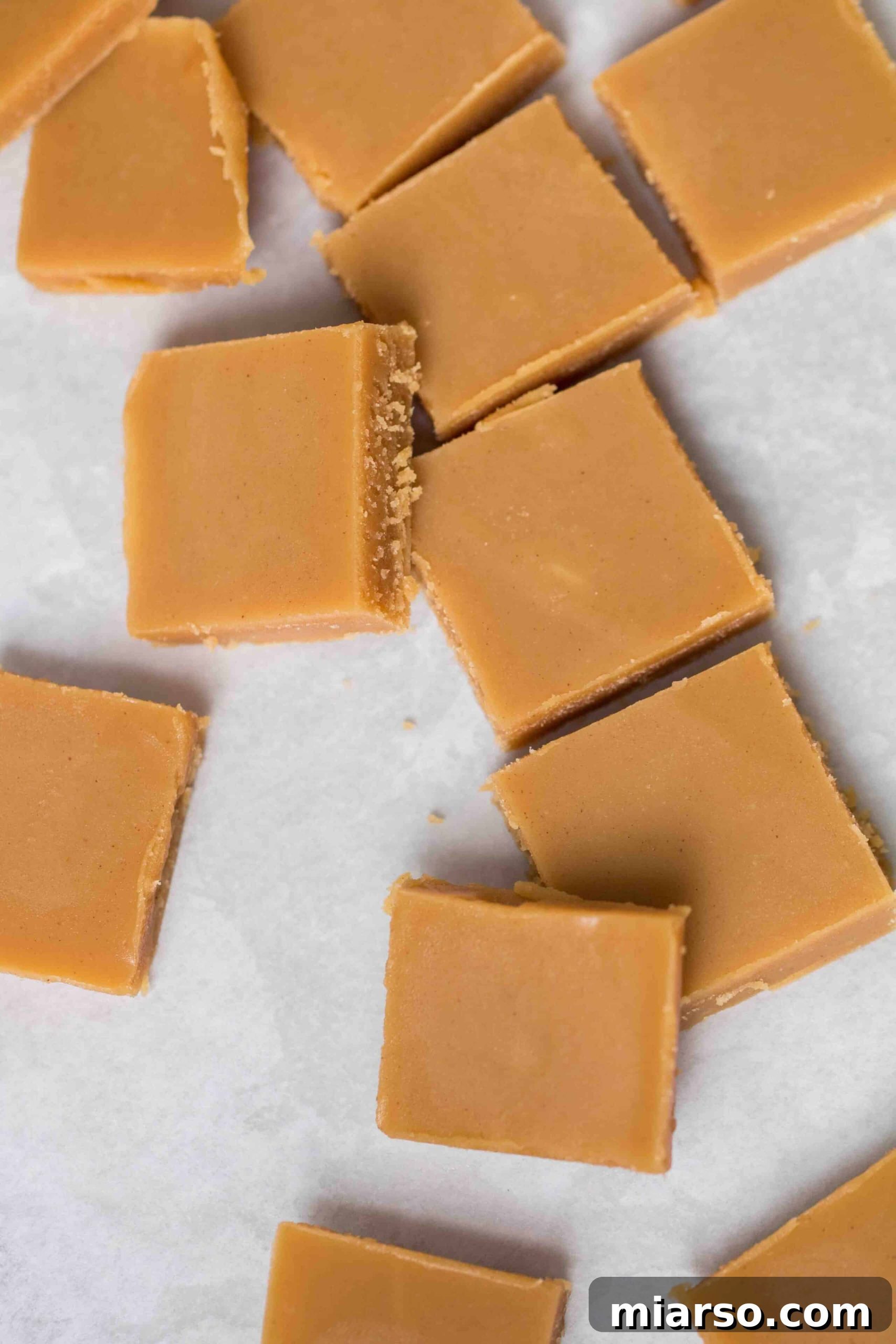 Perfectly cut keto peanut butter fudge squares arranged neatly, showcasing the creamy texture and inviting appeal.