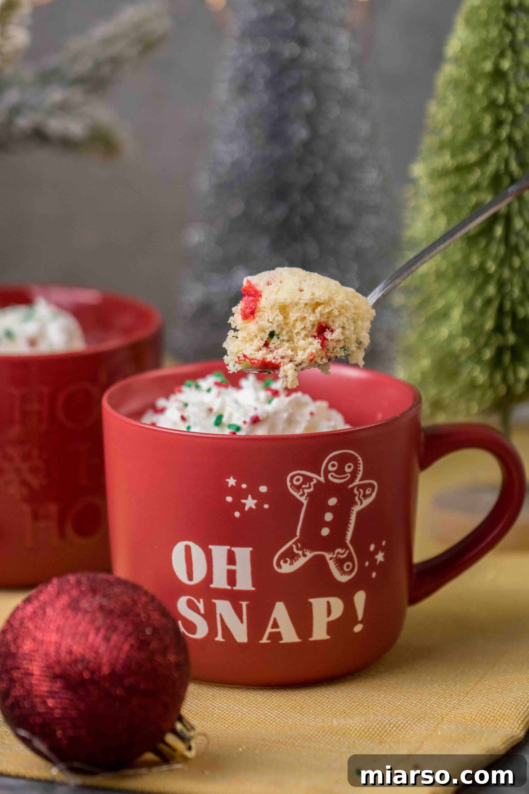 Festive Christmas mug cake adorned with sprinkles, ready to be enjoyed.