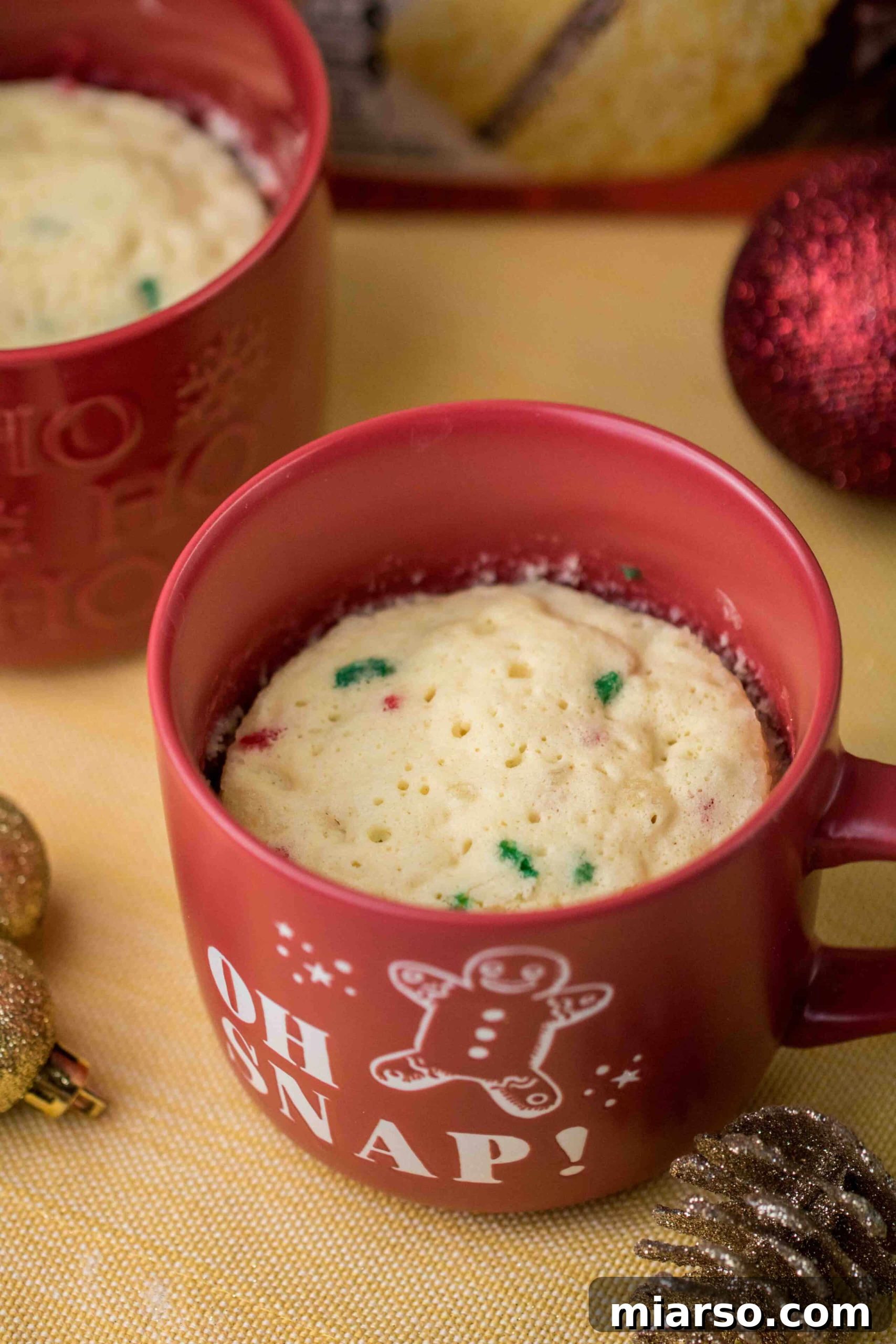 Visual guide to check mug cake doneness: spongy top when lightly touched.
