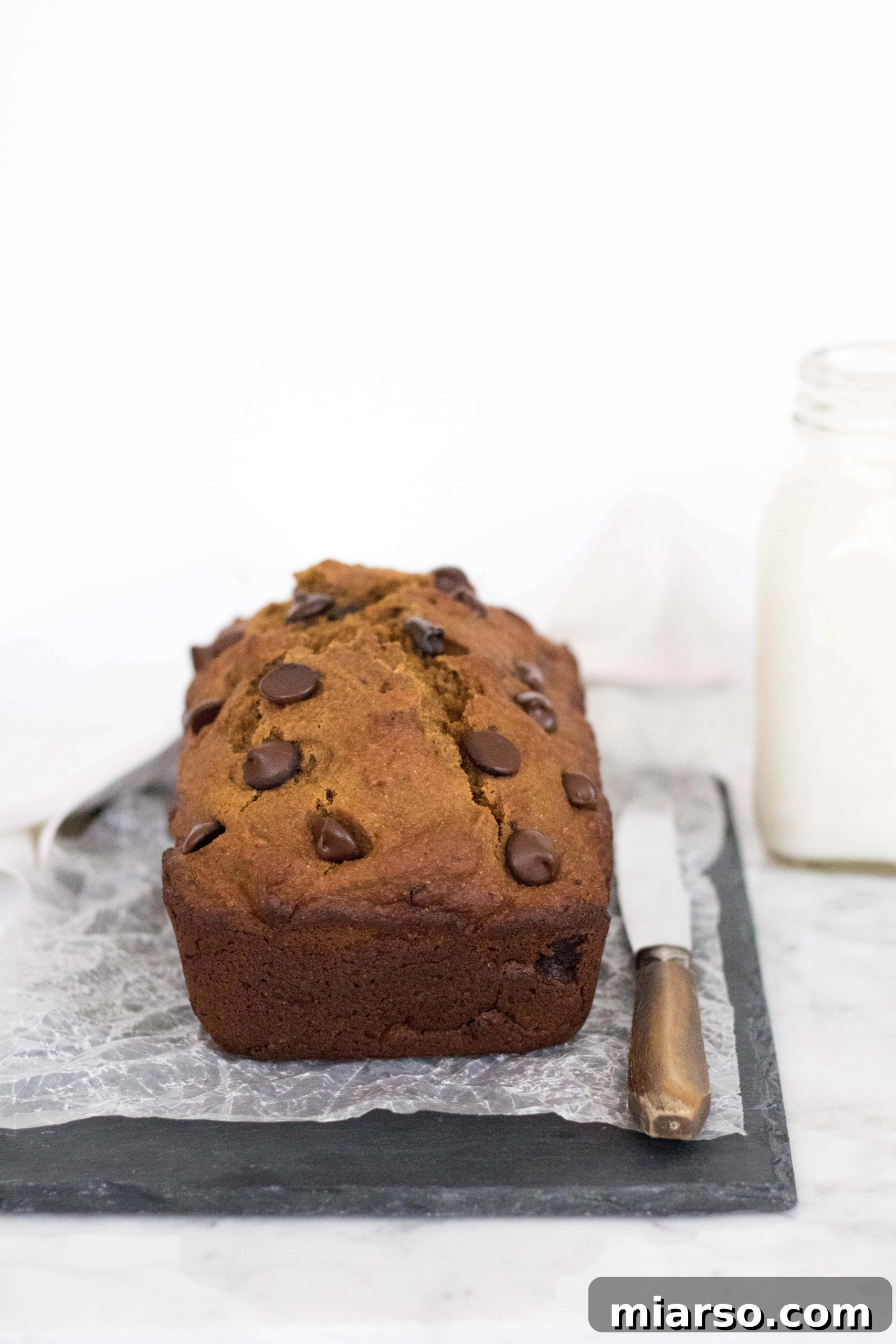Perfectly baked healthy pumpkin bread loaf, cooling on a wire rack, ready to be sliced.