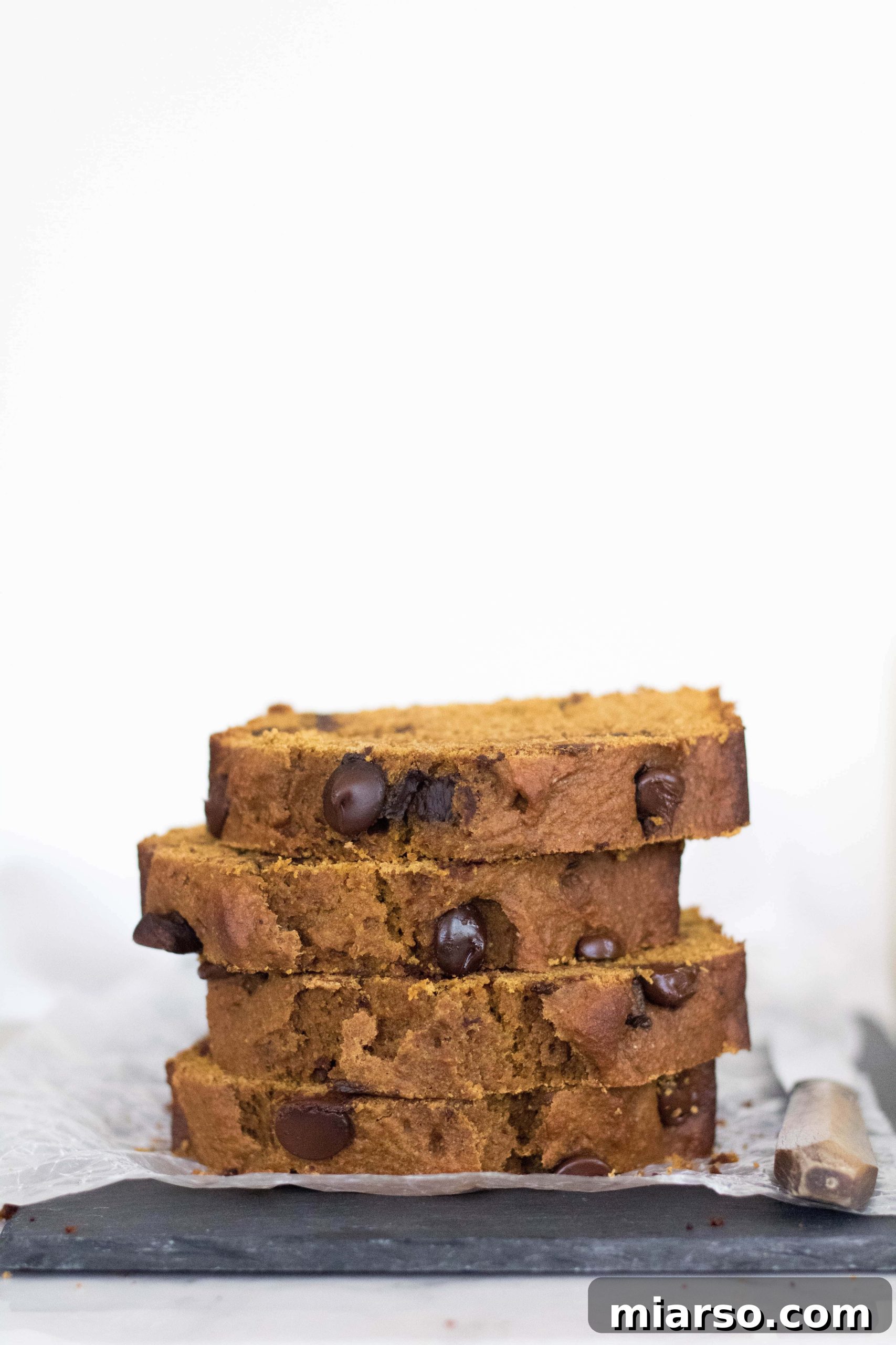 A beautifully sliced healthy pumpkin bread with chocolate chips, ready to be served.
