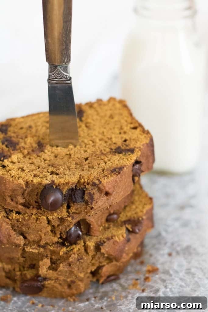 A delicious slice of healthy pumpkin bread with a hot beverage, ideal for a cozy fall moment.
