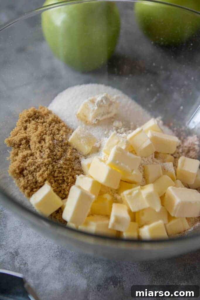 Crumbly streusel topping mixture in a bowl, ready to be added to the pie.