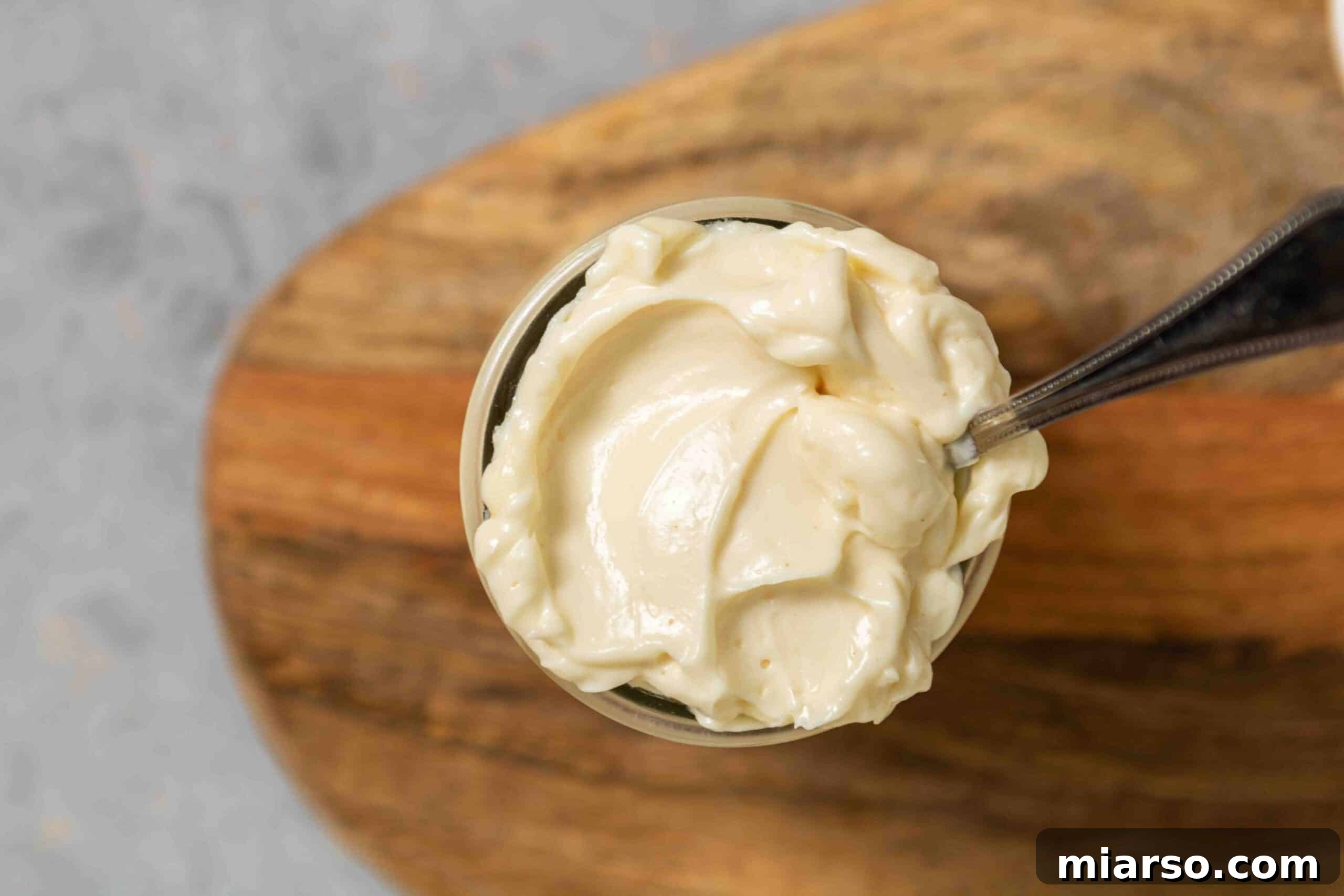 Overhead shot of mayo in a jar with beautiful texture, ready to be used.