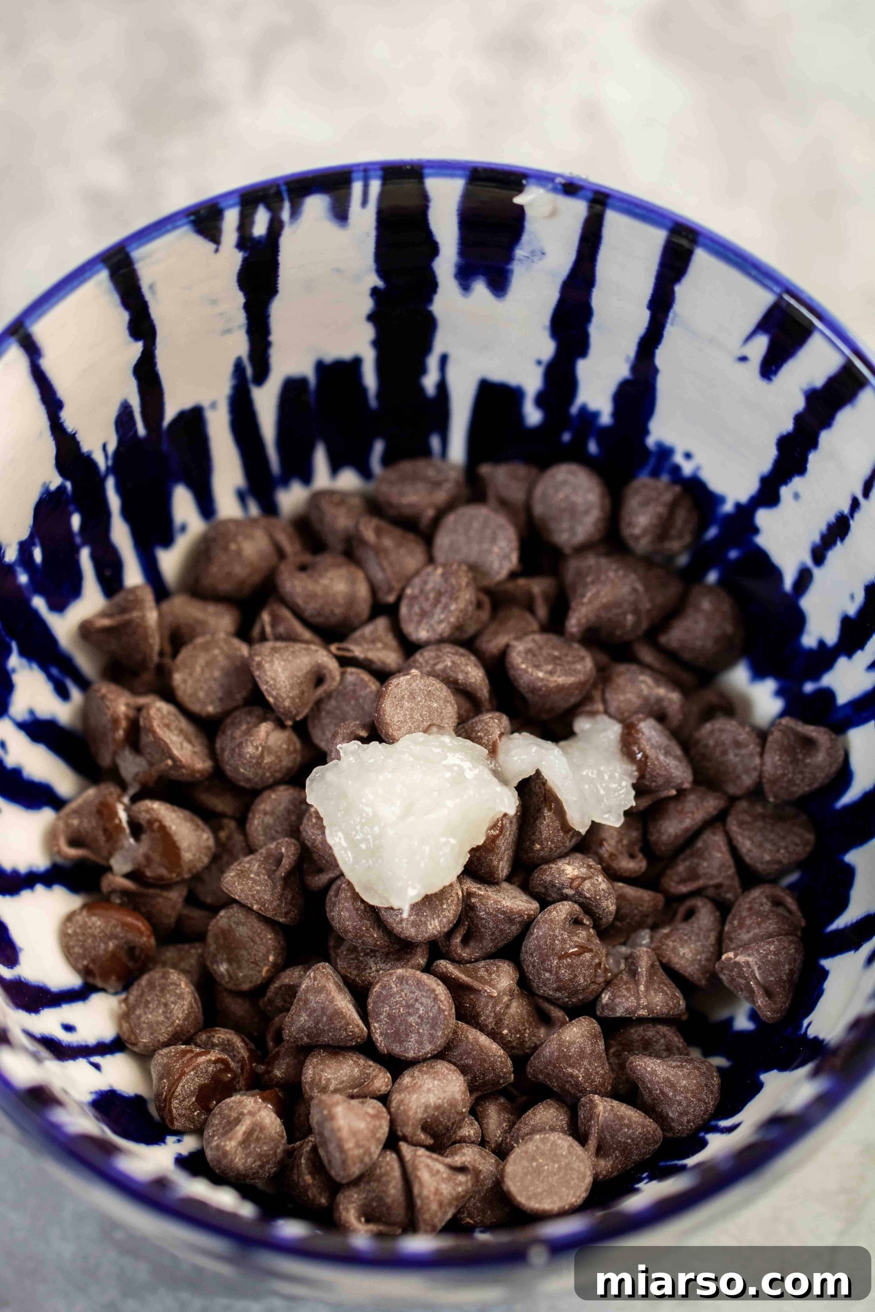 Melted chocolate chips and coconut oil in a bowl, ready for dipping.