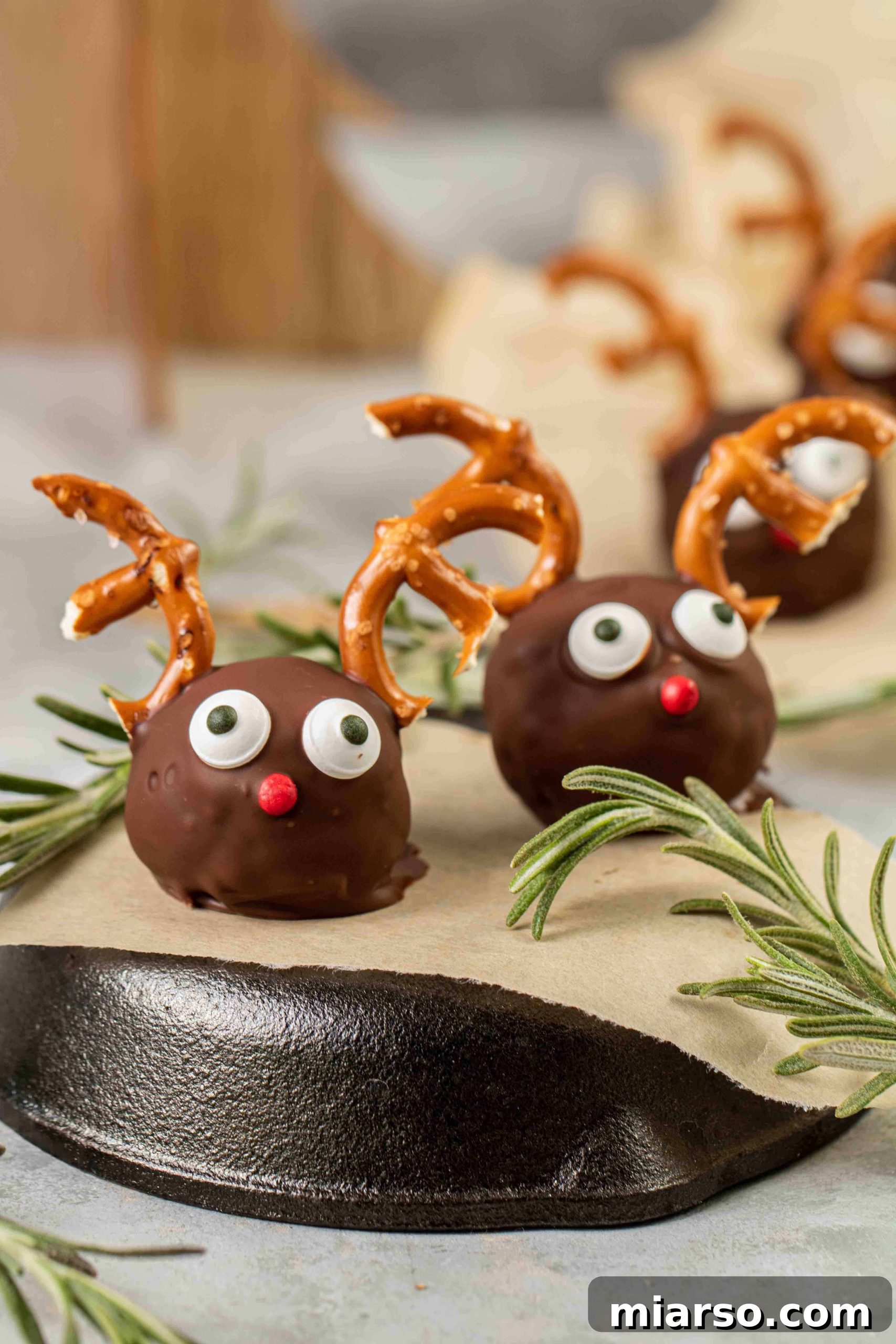 Close up of a finished Healthy Reindeer Peanut Butter Ball with Rice Krispies, showcasing its details.