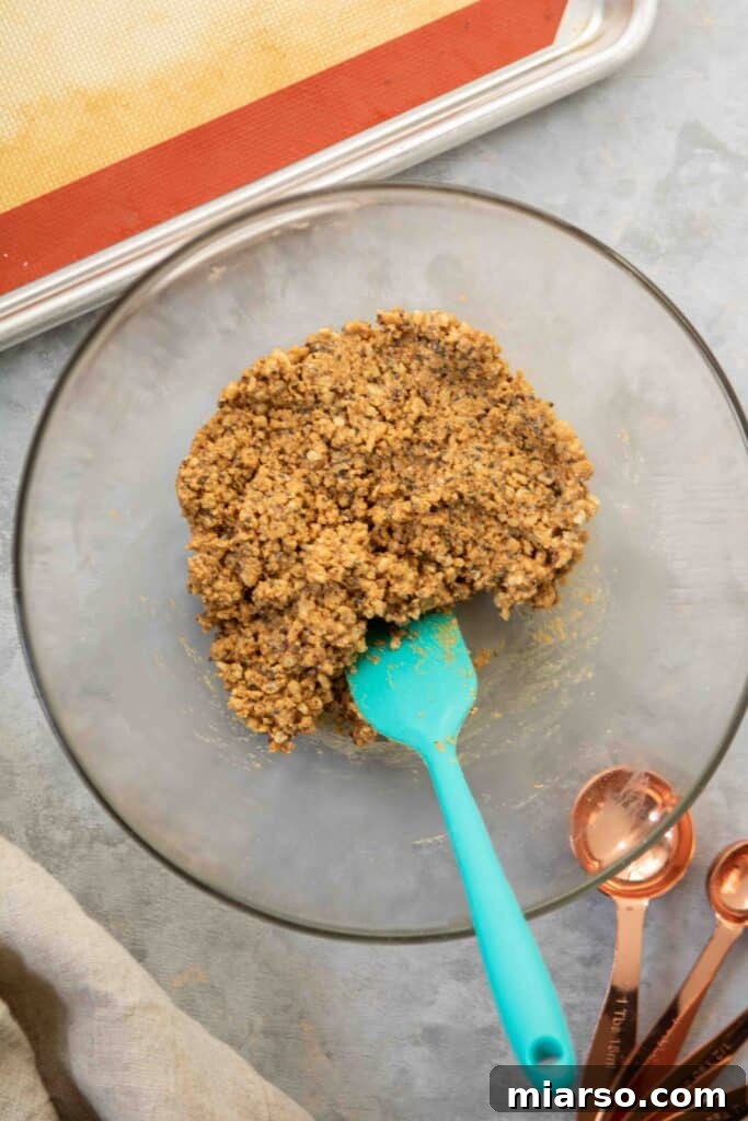 How to make reindeer peanut butter balls: Adding crushed rice cereal to the mixture.