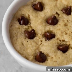 Close up shot of top of the vegan chocolate chip cookie with melted chocolate chips.