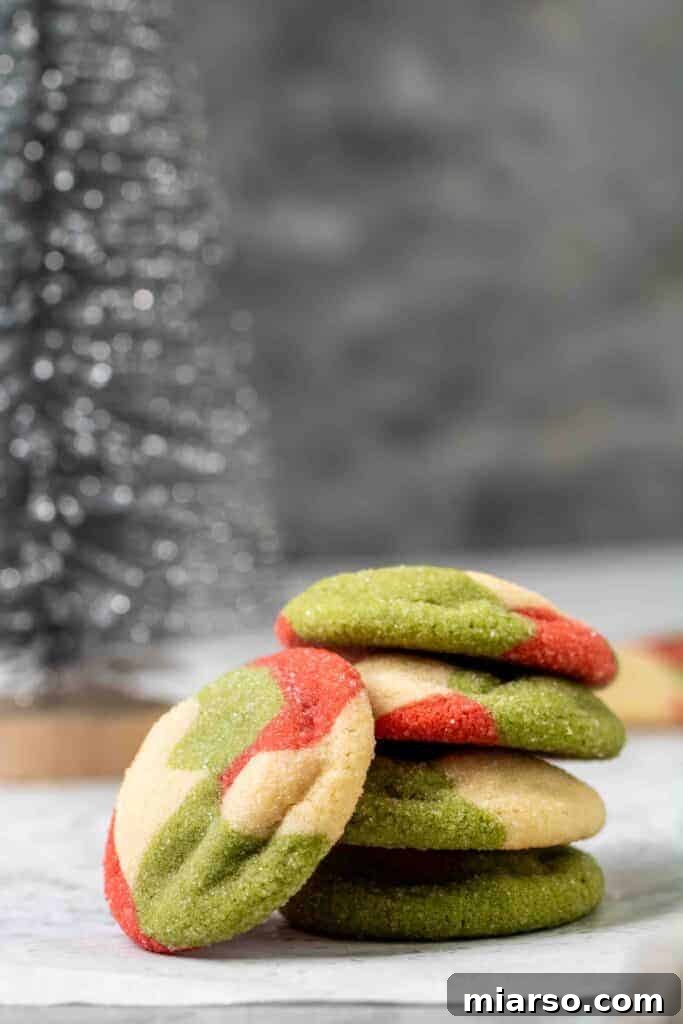 Stack of freshly baked marbled red, white, and green sugar cookies