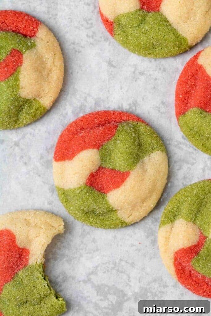 Close-up of red, green, and white marbled sugar cookies stacked on a plate