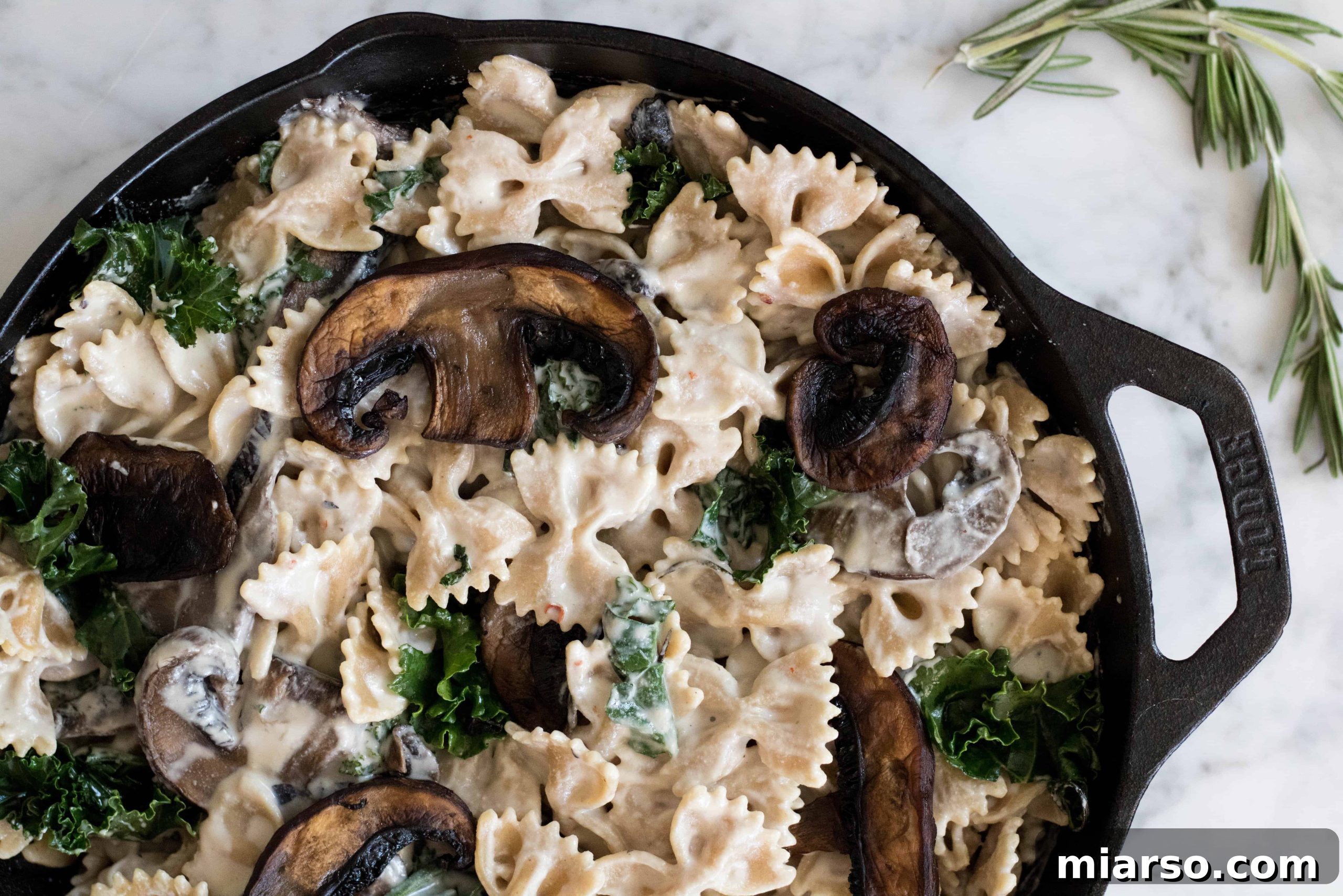 Vegan creamy Kale & mushroom pasta, showcasing a vibrant and healthy plant-based dish.