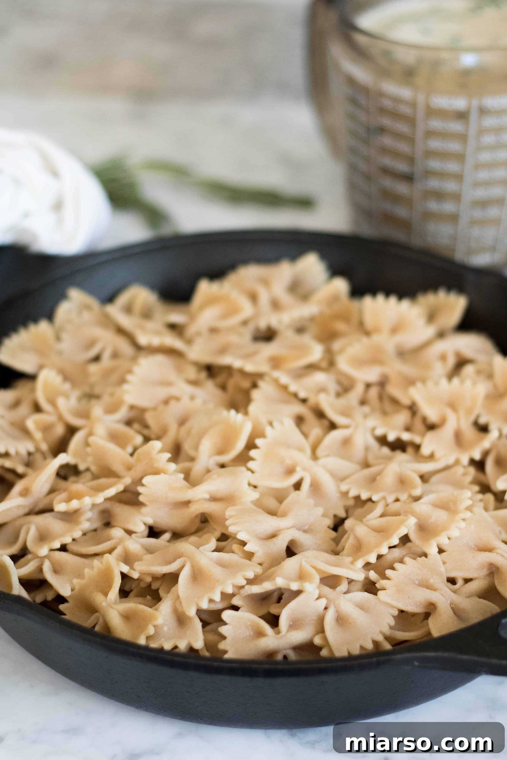 A close-up shot of the creamy vegan kale and mushroom pasta, highlighting the rich sauce and fresh ingredients.
