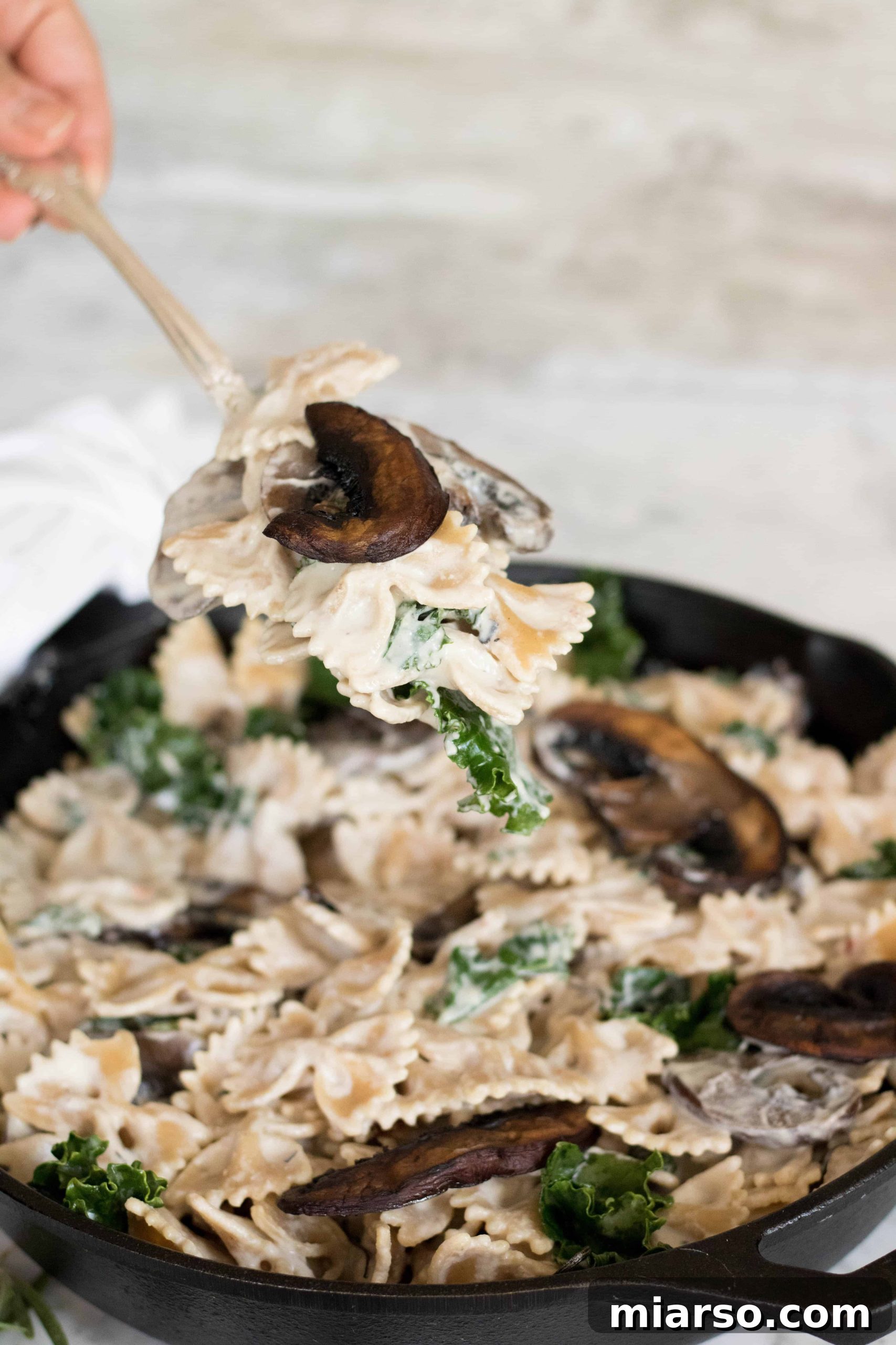 Overhead shot of the vegan creamy mushroom pasta, ready to be served, showcasing its vibrant presentation.