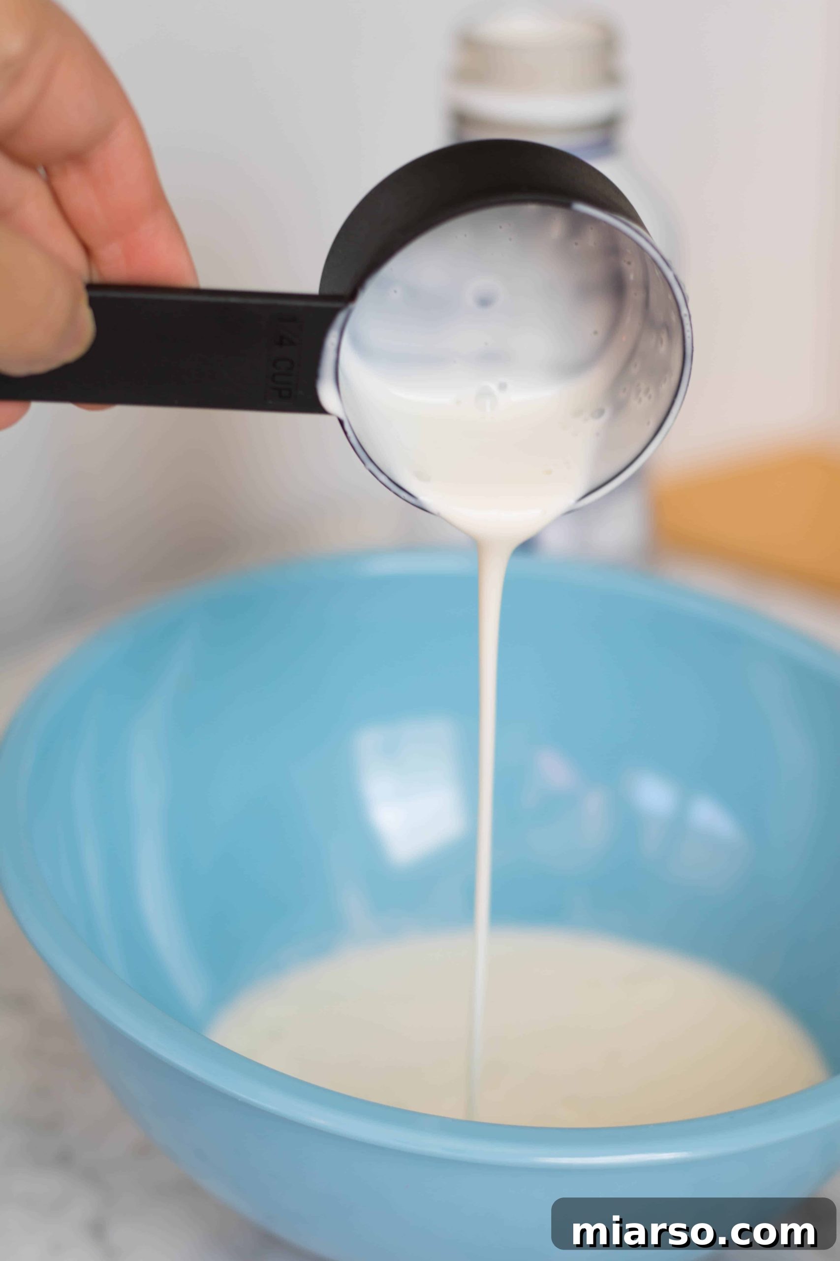 Heavy whipping cream in a bowl, ready to be whipped