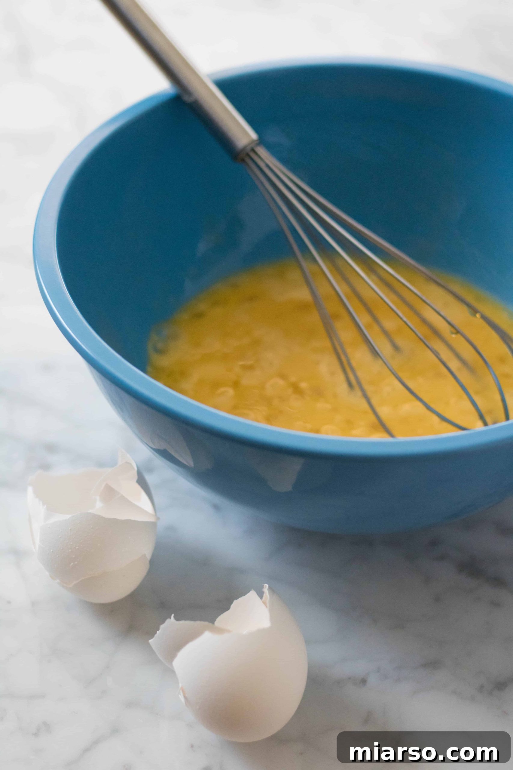Whisking eggs and honey for brownie batter