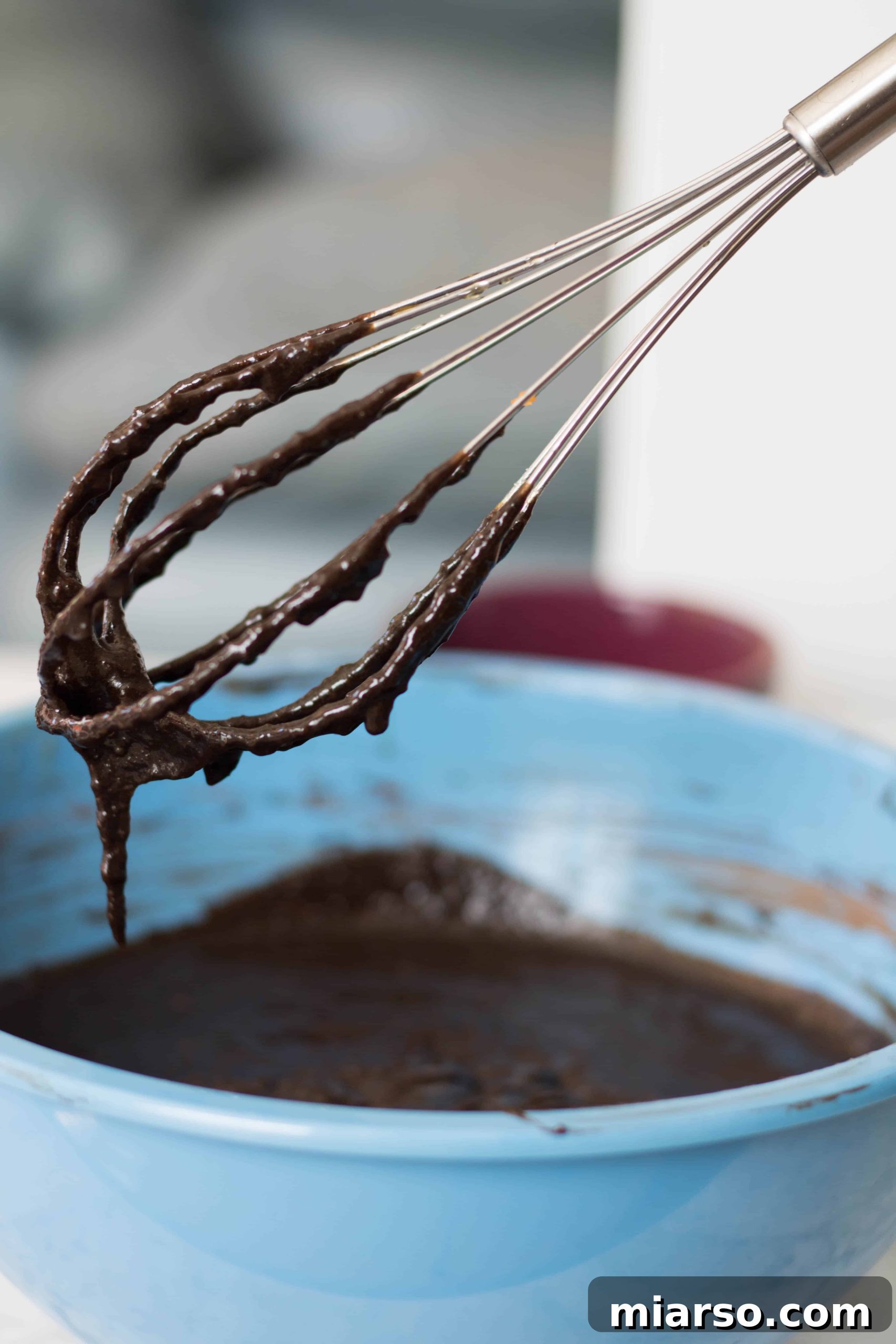 Folding almond flour and cacao powder into sweet potato brownie batter