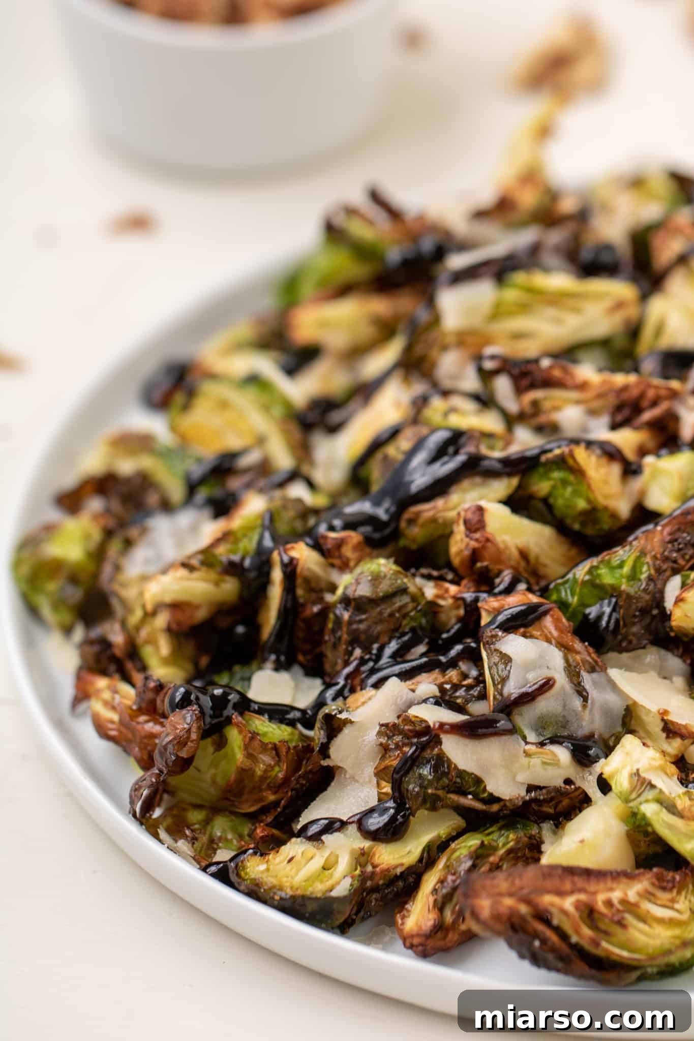 Air Fryer Brussel Sprouts with Parmesan and Balsamic Glaze in a bowl