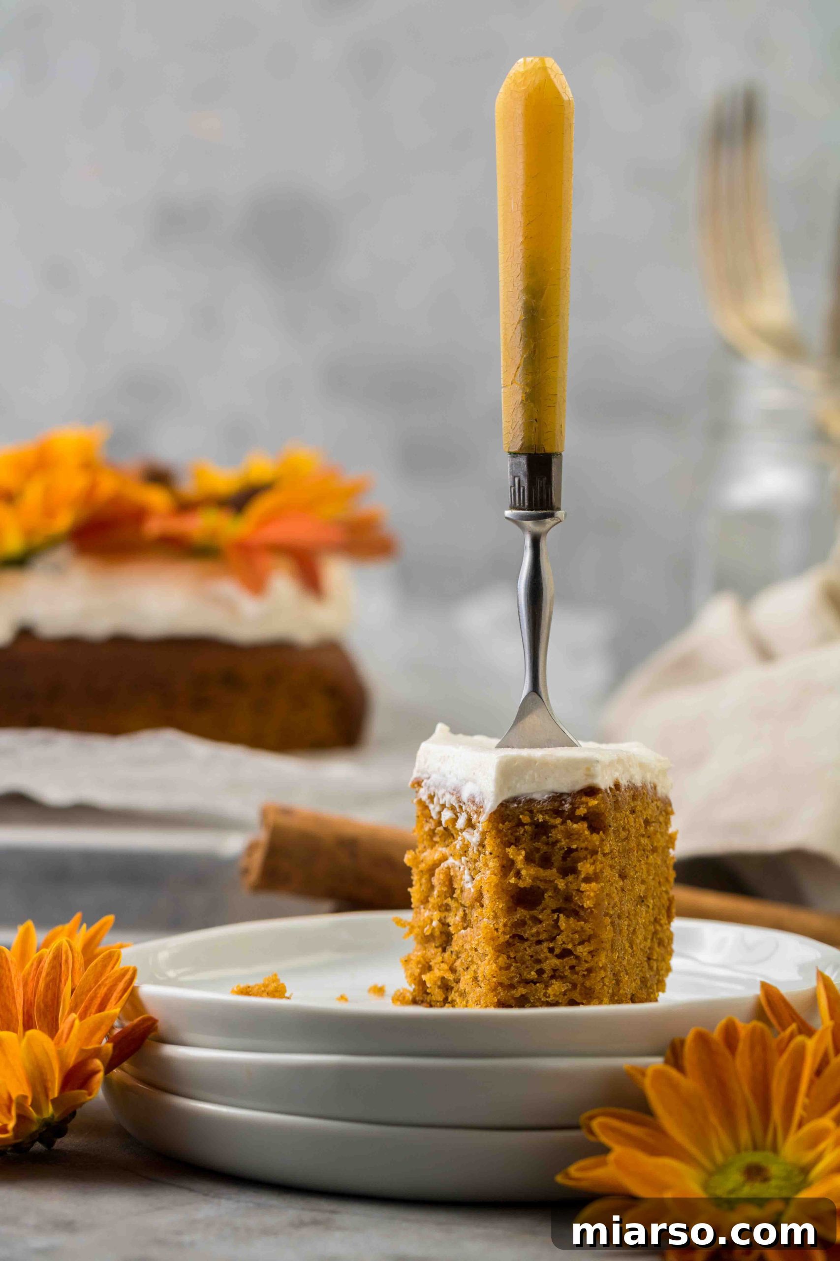 The Easiest Pumpkin Sheet Cake, sliced and served