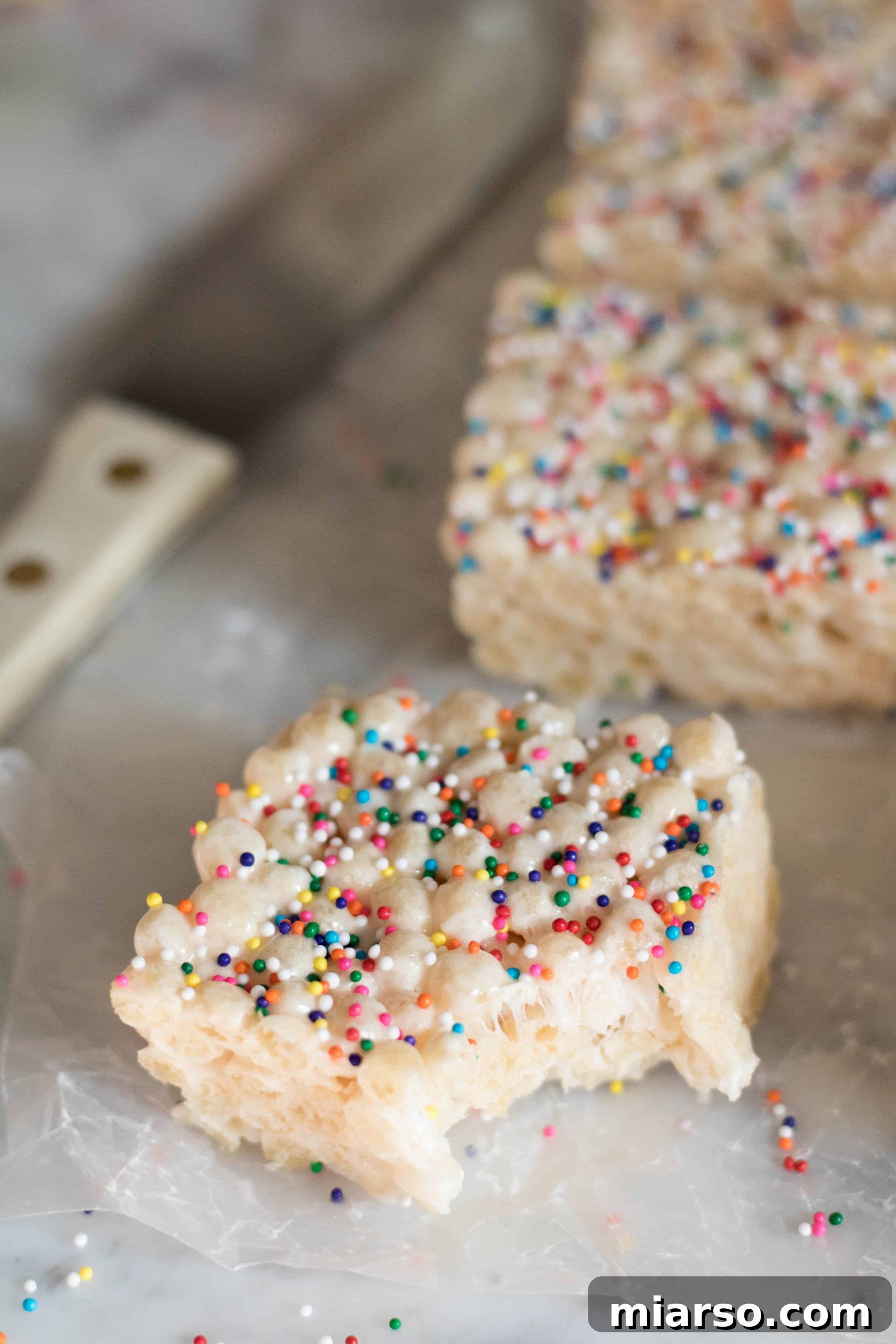Overhead shot of Quinoa Pop Krispie Treats in a pan, with a piece cut out
